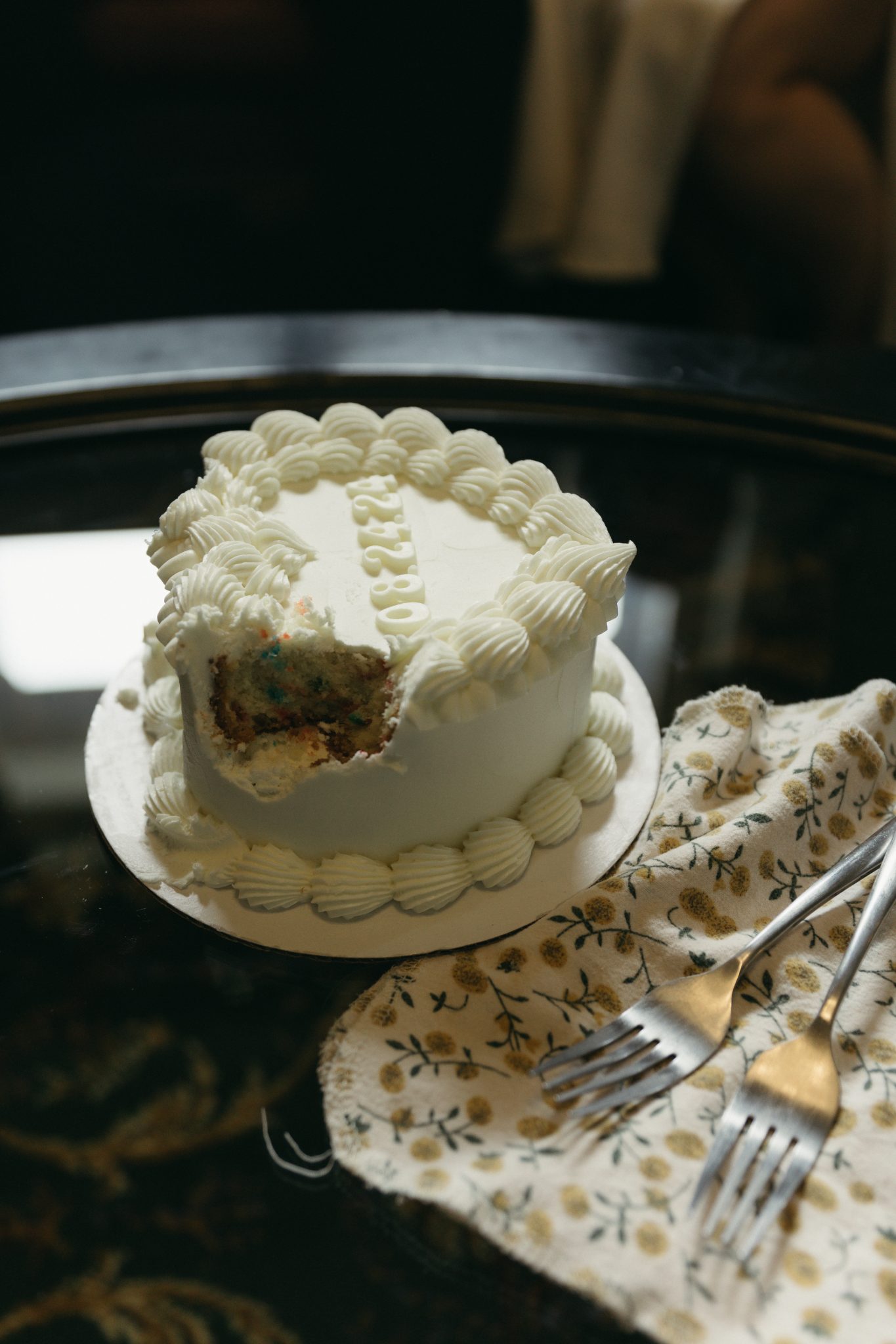 A close-up of a wedding cake with a slice missing, part of a wedding engagement session in Idaho.