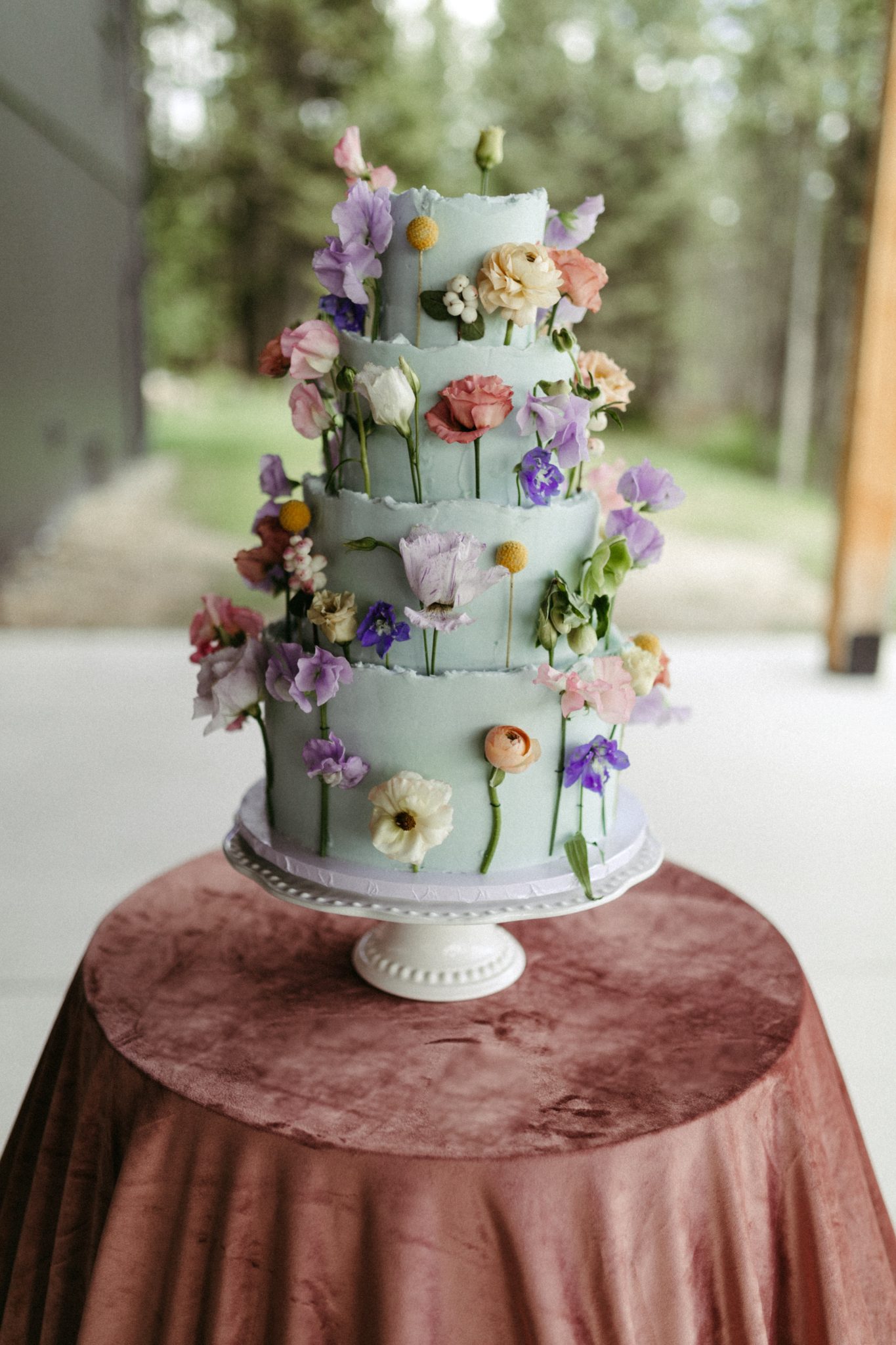 Whimsical floral wedding cake at a Bridgerton-themed bridal brunch.