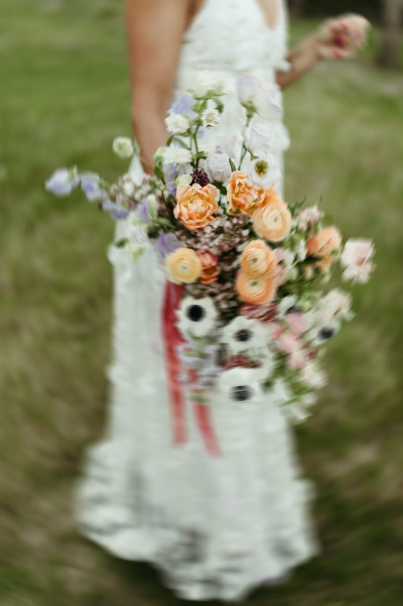 Bride holding a colorful bouquet of flowers at a Bridgerton Bridal Brunch.
