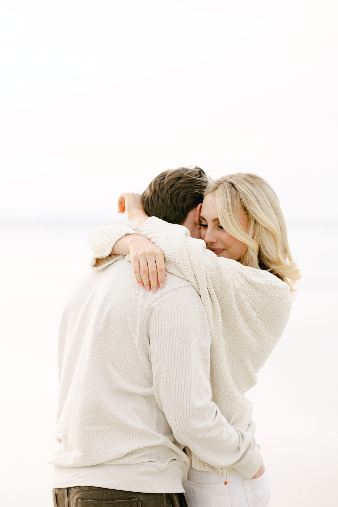 Romantic hug between a couple during their engagement shoot at Utah's pink lake.