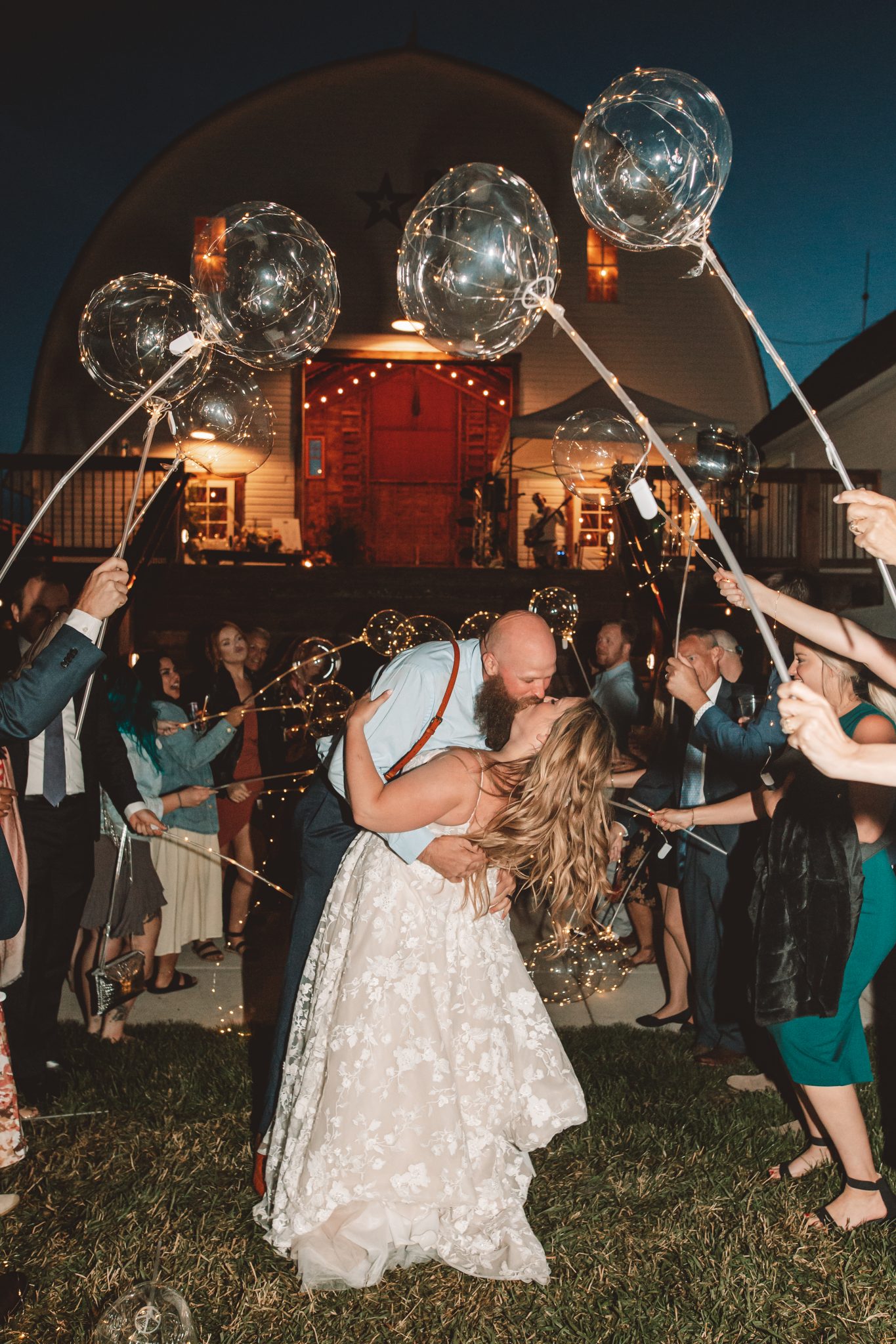 Bride and groom sharing a kiss during a sparkler exit at a Montana Summer Wedding
