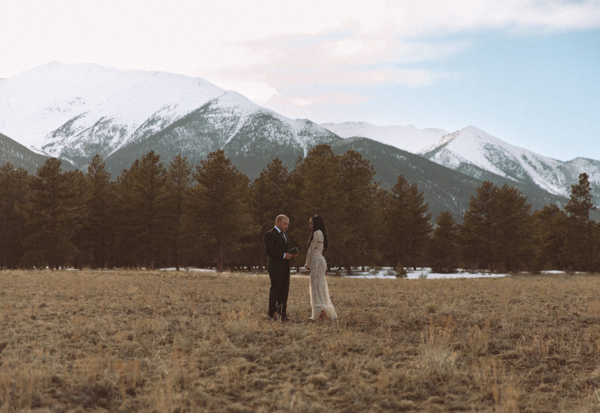 he couple exchanges heartfelt vows amidst the majestic Colorado mountains during their simple mountain elopement.