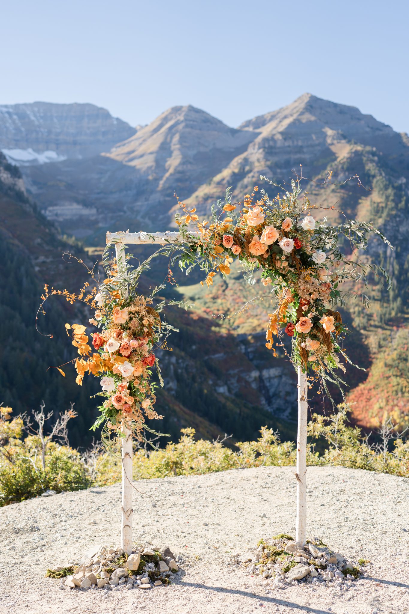 Stunning outdoor ceremony setup with mountain views and autumn floral arrangements at a Utah fall wedding