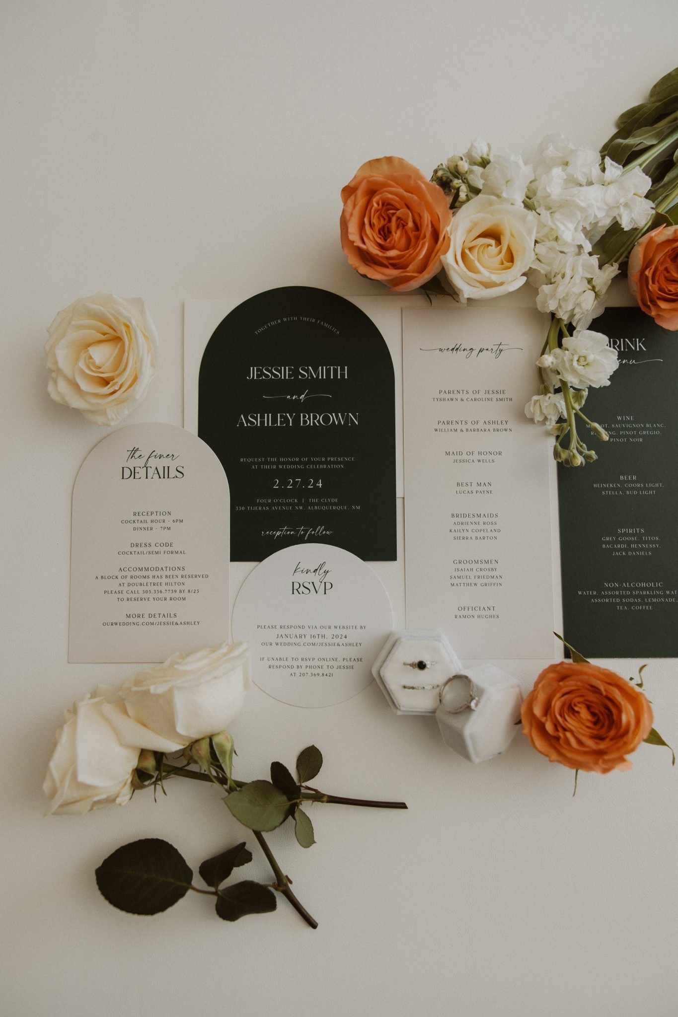 Stylish wedding invitations and details arranged with roses, setting the tone for an Albuquerque wedding.