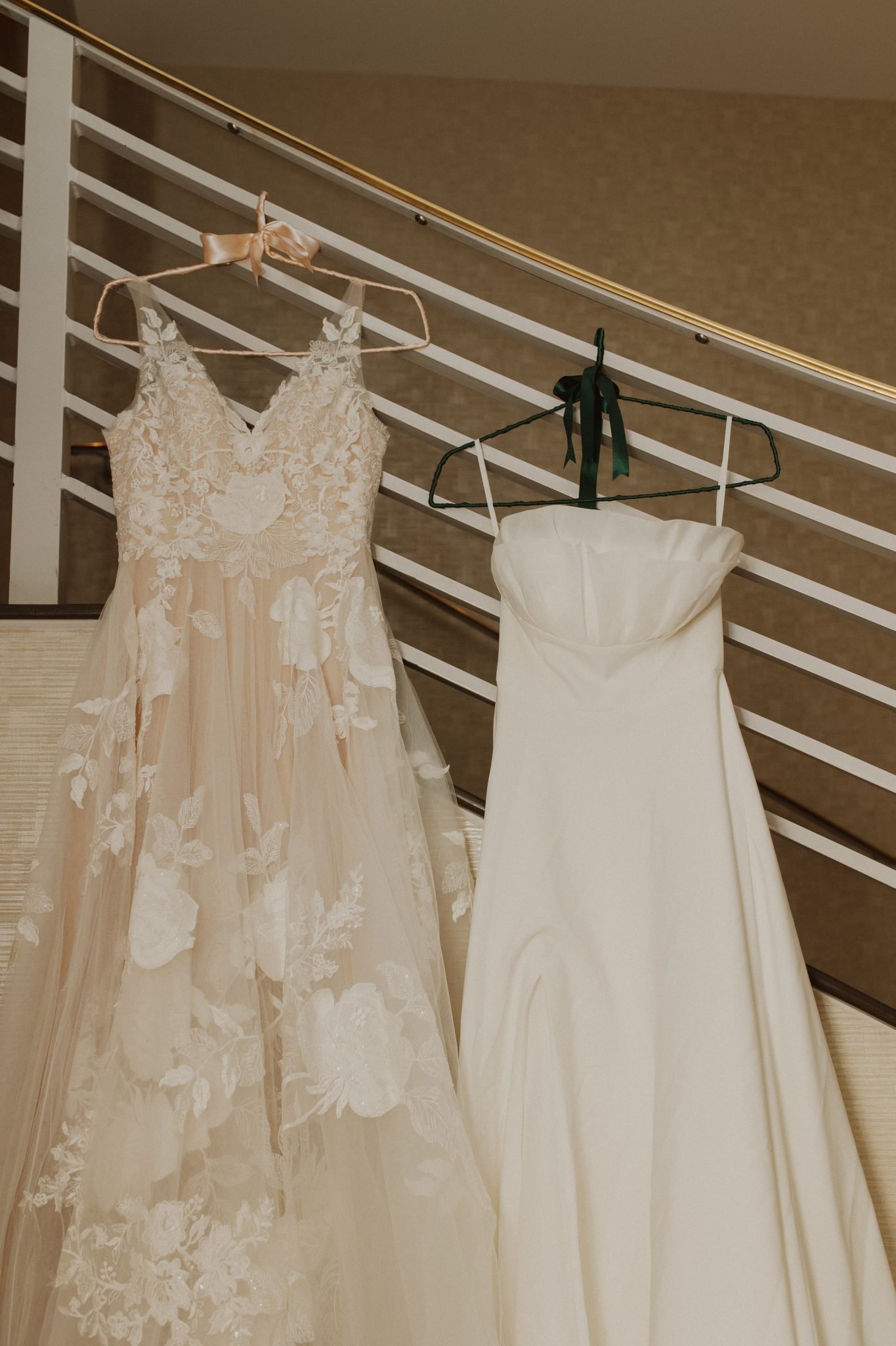 Two wedding dresses hanging gracefully, capturing the essence of an Albuquerque wedding.