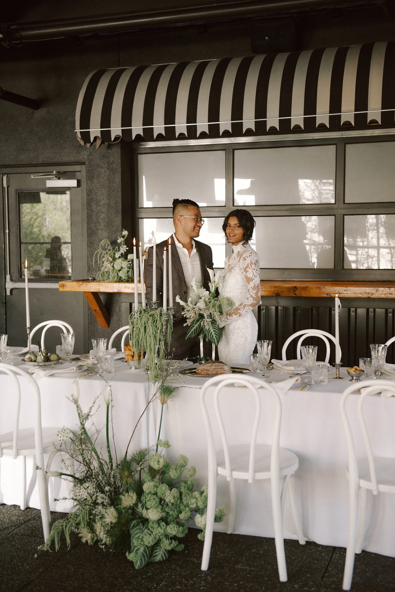 Groom and bride sharing a moment by the reception table at Slate Vancouver Wedding.