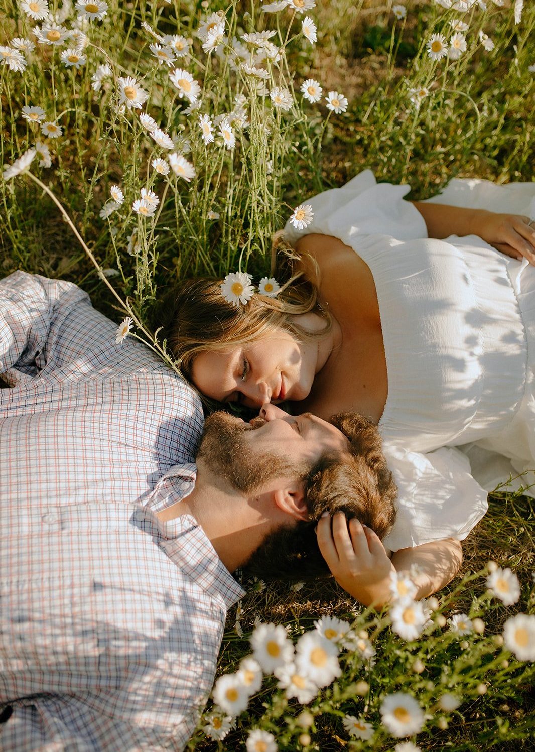 A close-up shot of the couple’s hands intertwined with wildflowers in the background during their Durango engagement session.