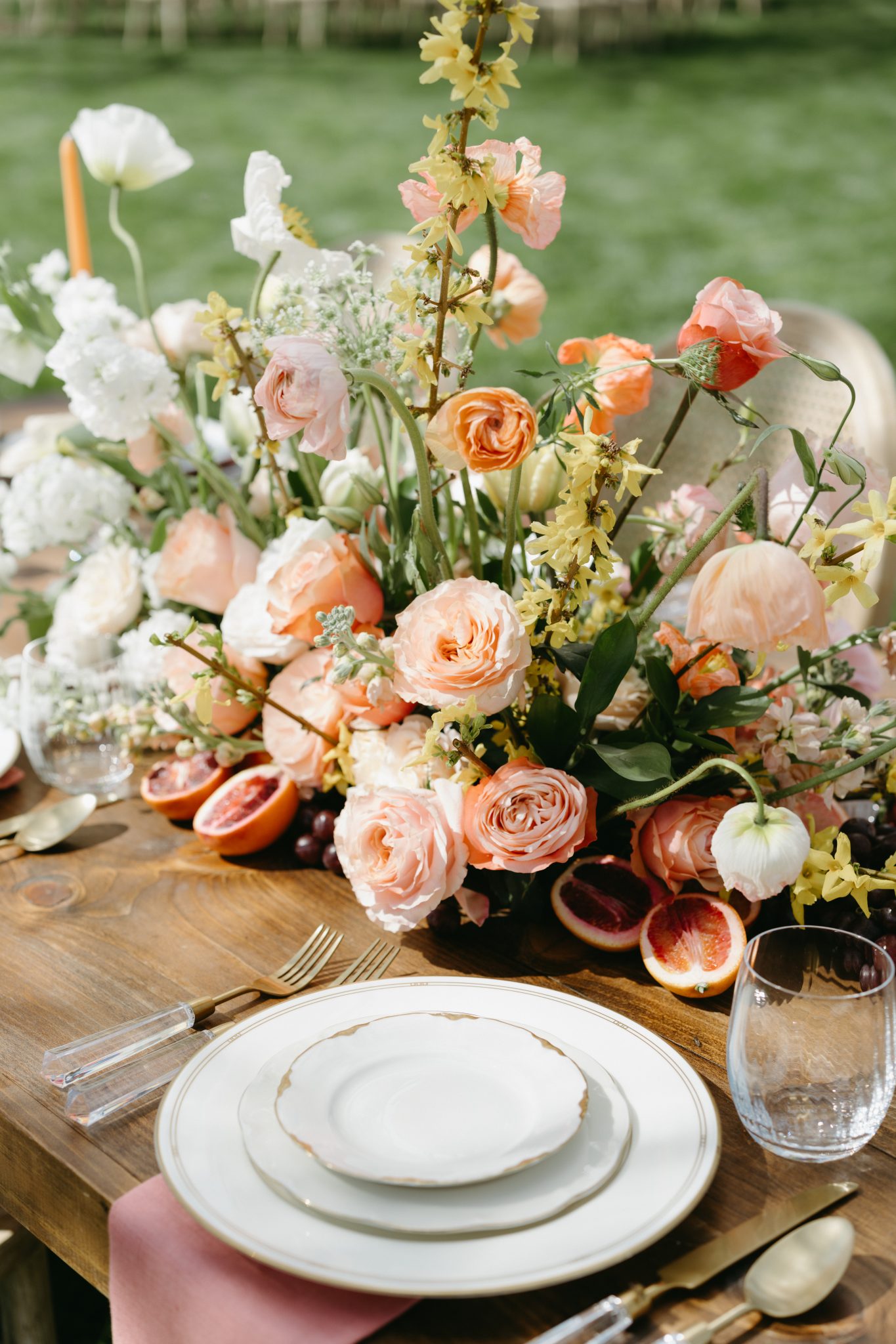Rustic outdoor wedding reception setup with a beautifully decorated wooden table in Idaho during spring.