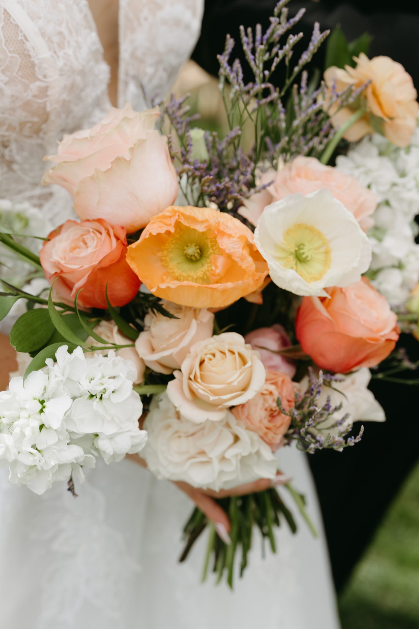 A vibrant bouquet of pastel and orange flowers, perfect for spring Idaho wedding inspiration.