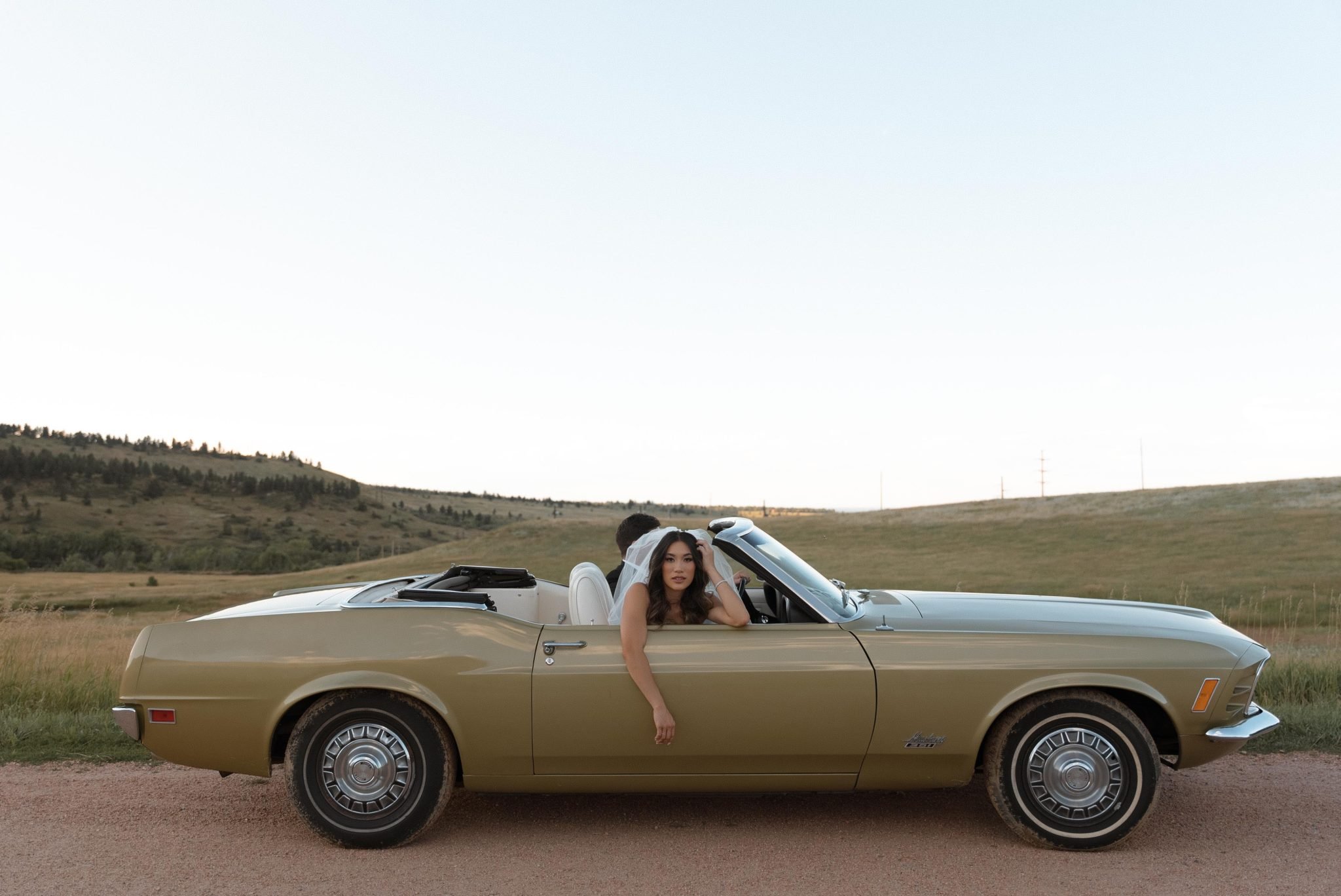 Couple enjoying a romantic Boulder engagement session in a classic convertible.