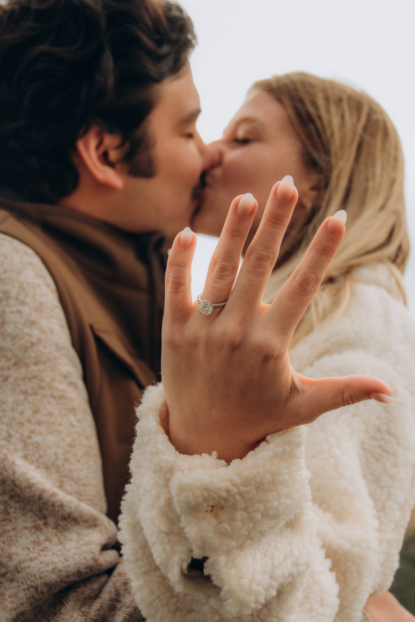 Close-up of a couple kissing, showcasing the engagement ring in a surprise Wyoming proposal.