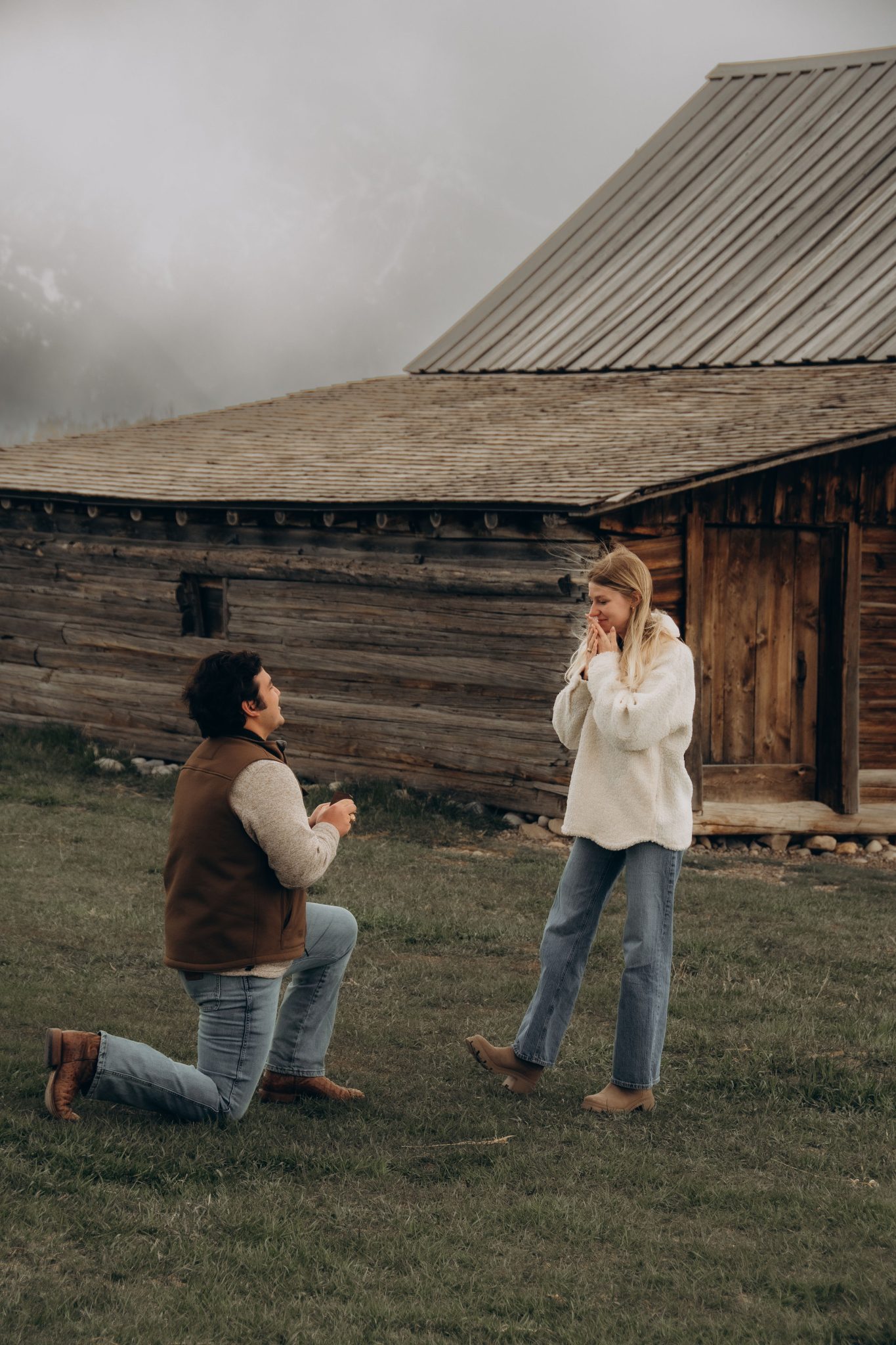 Man proposing to his girlfriend in a rustic setting in Wyoming.