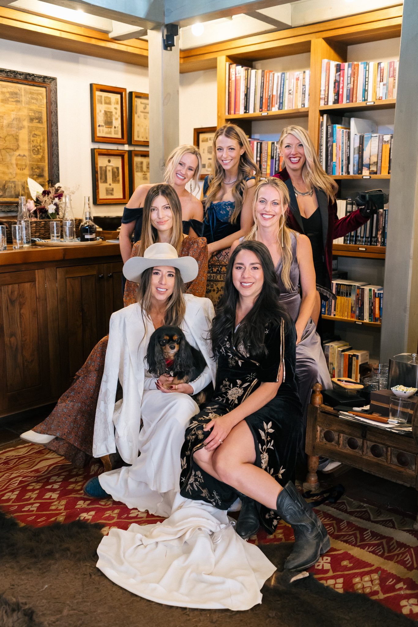 Bride and her bridesmaids gathered inside a cozy library, smiling together before the Dunton Hot Springs Wedding ceremony.