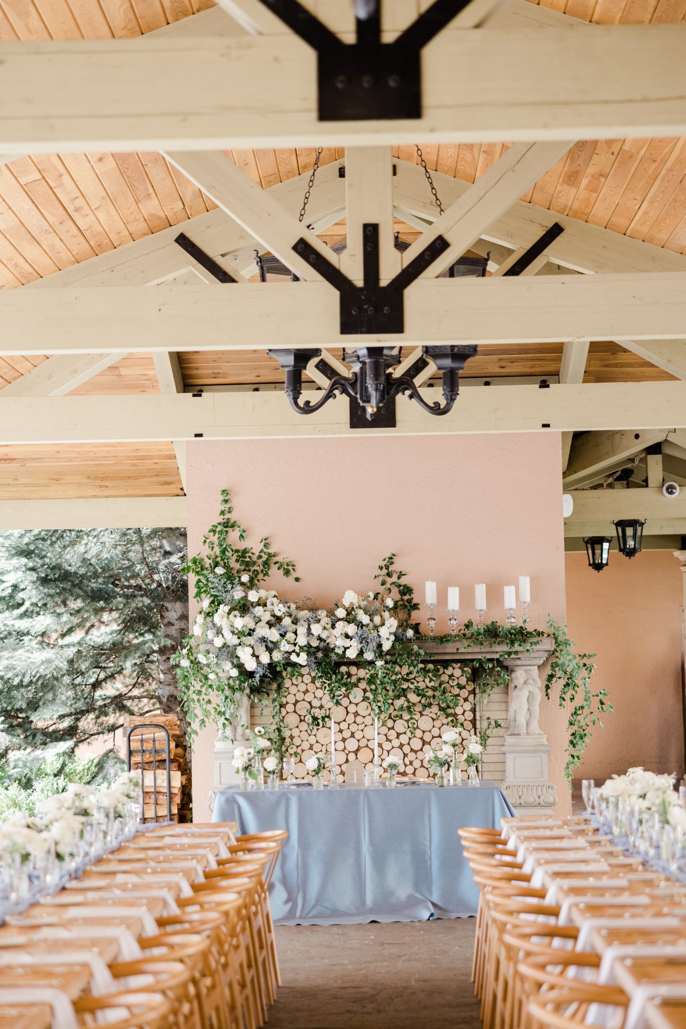 A floral-decorated mantelpiece with candles as part of the elegant reception décor at The Broadmoor Chic Summer Wedding.