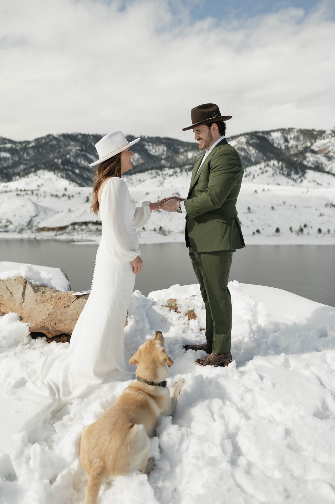 Bride and groom exchanging vows in the snow, with their dog by their side, at a Fort Collins Colorado snowy elopement.