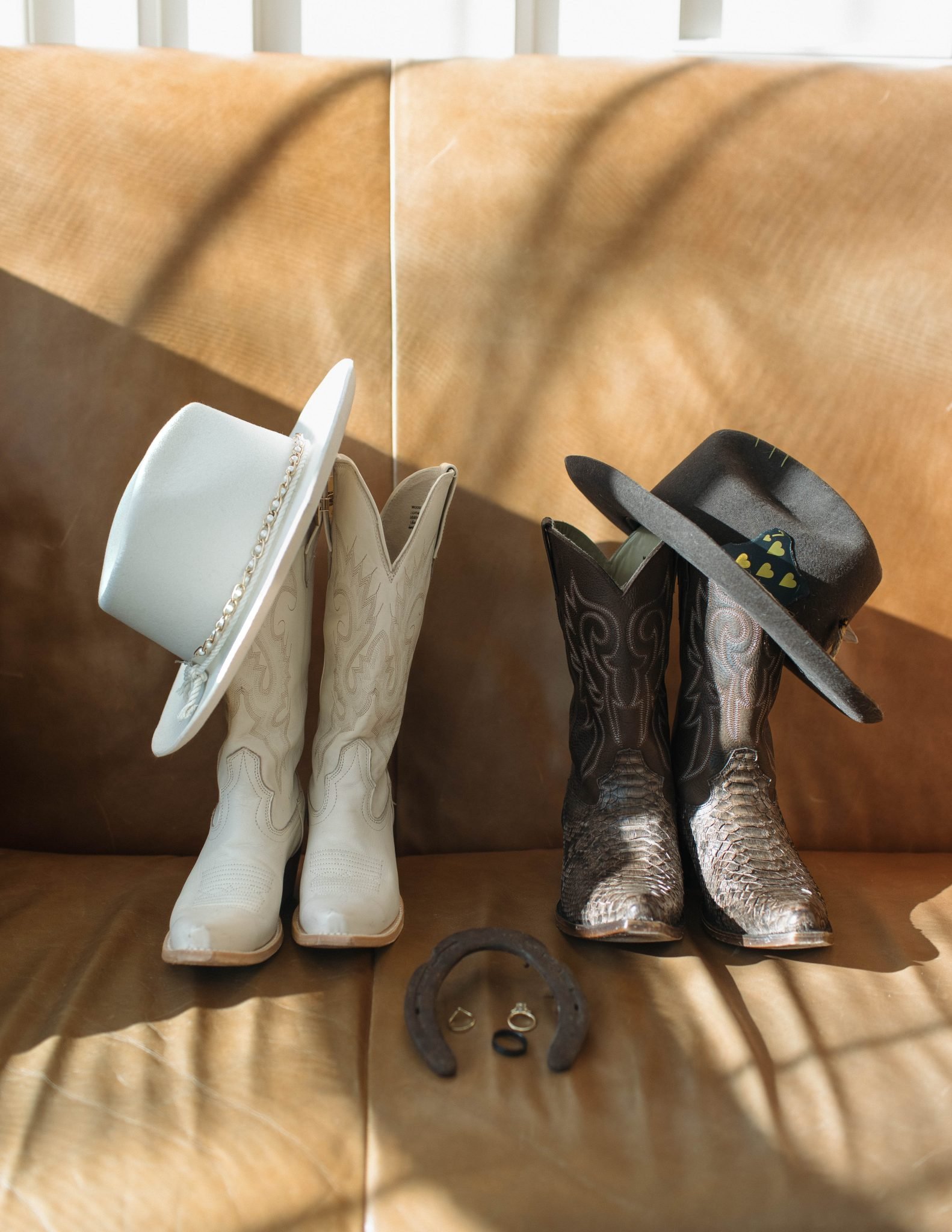Cowboy boots and hats styled with wedding rings for a rustic Fort Collins Colorado snowy elopement.
