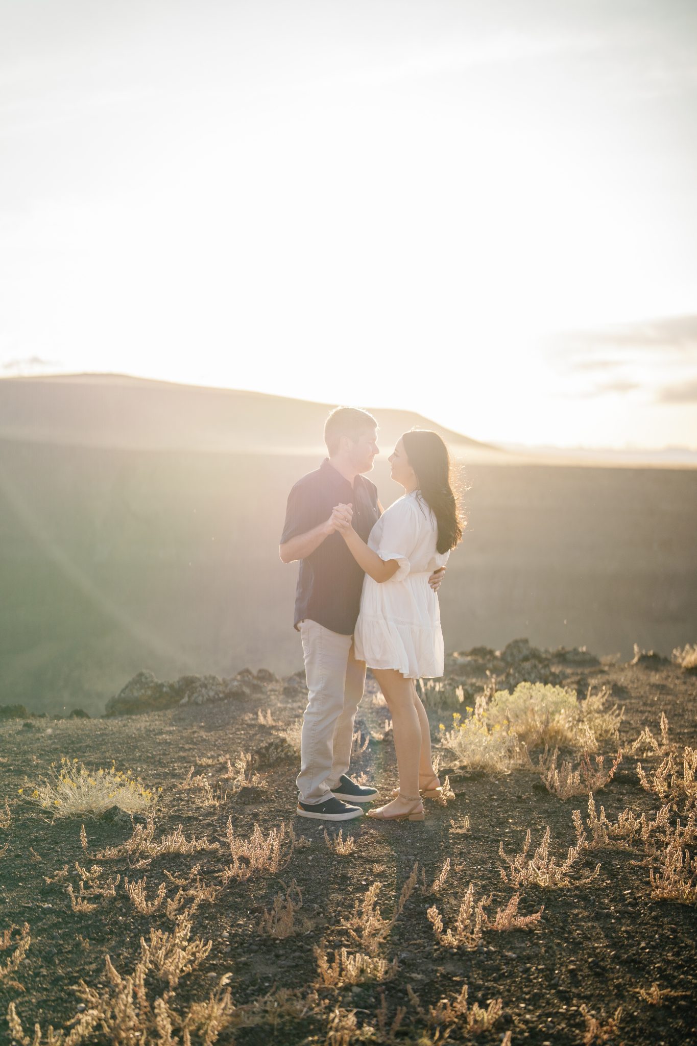 Engaged couple dancing in the golden hour light during their Idaho engagement session