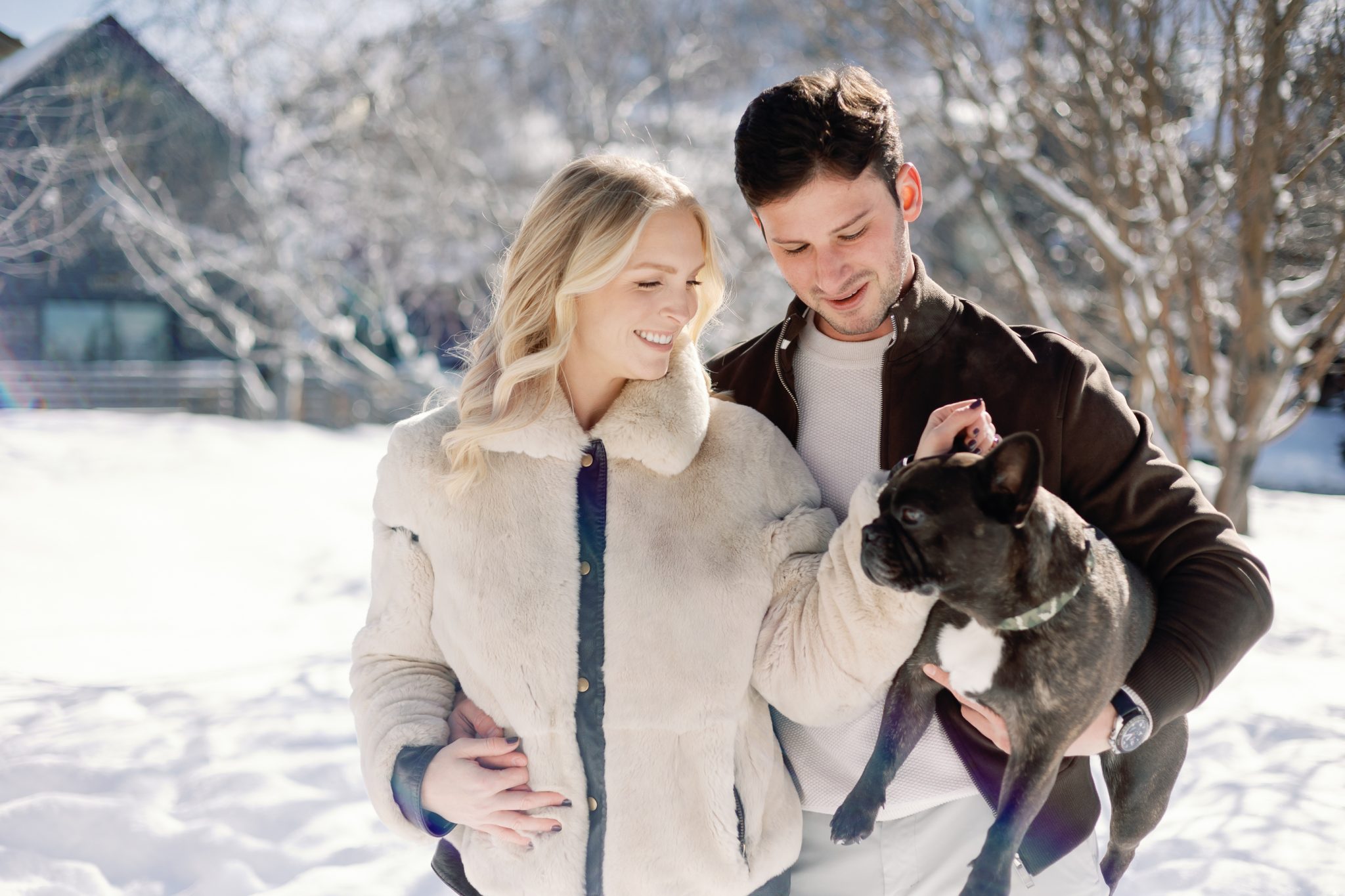A couple enjoying a winter day with their French Bulldog in Park City, captured during their engagement session.