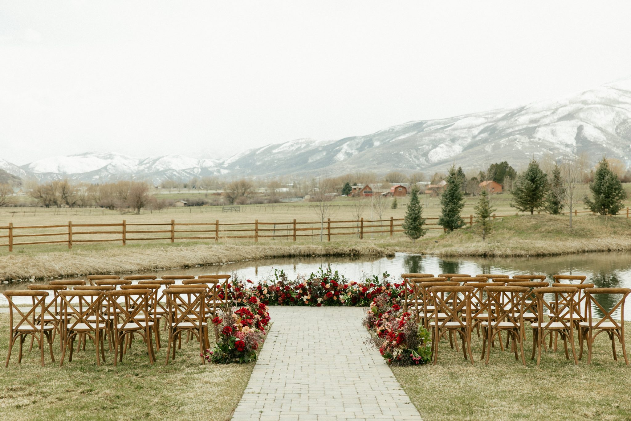 Outdoor winter ceremony setup with snowy mountain views at River's Bottom Ranch during a winter snowy Utah wedding.