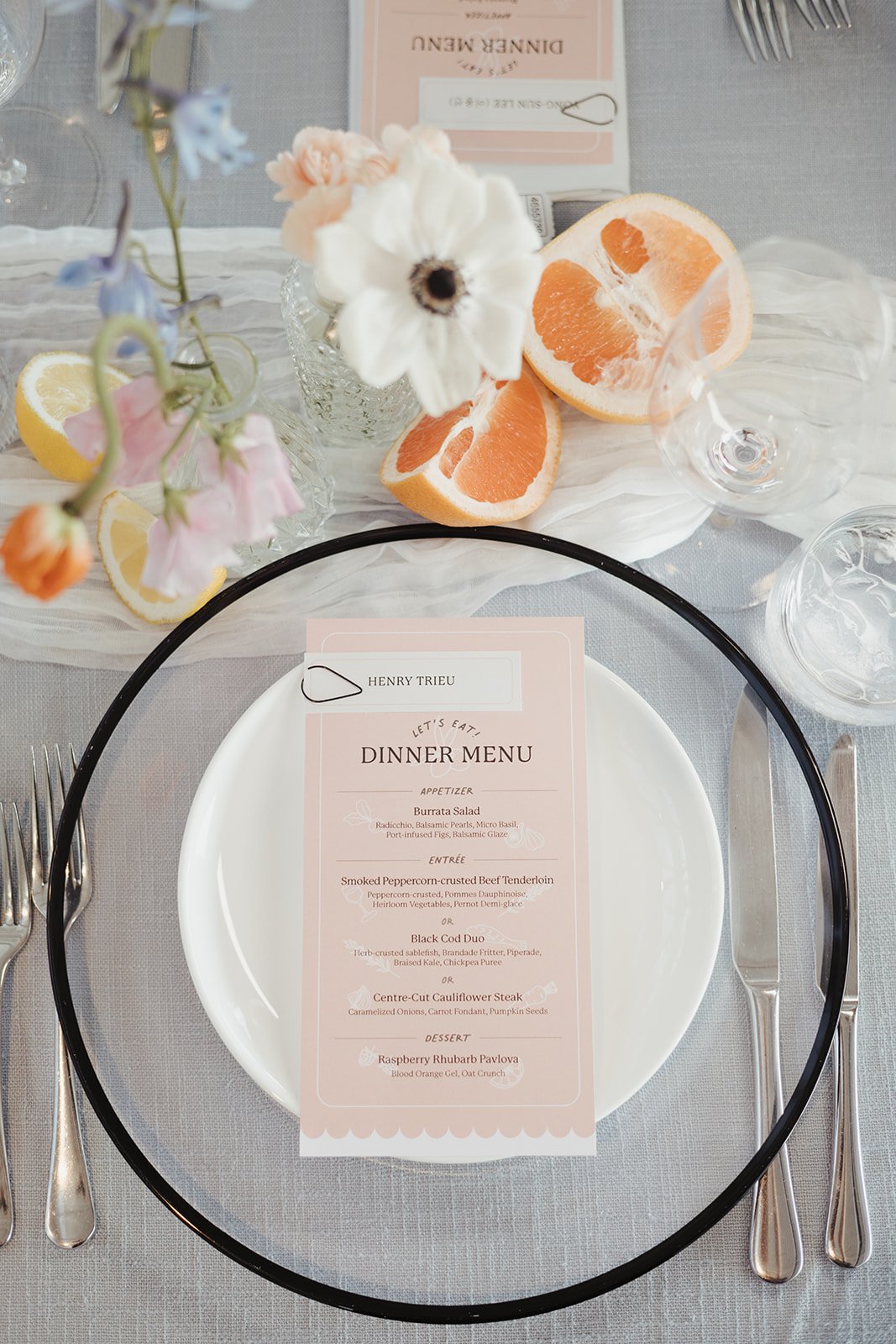 Elegant dinner menu and citrus-inspired table decor at a British Columbia elegant wedding.