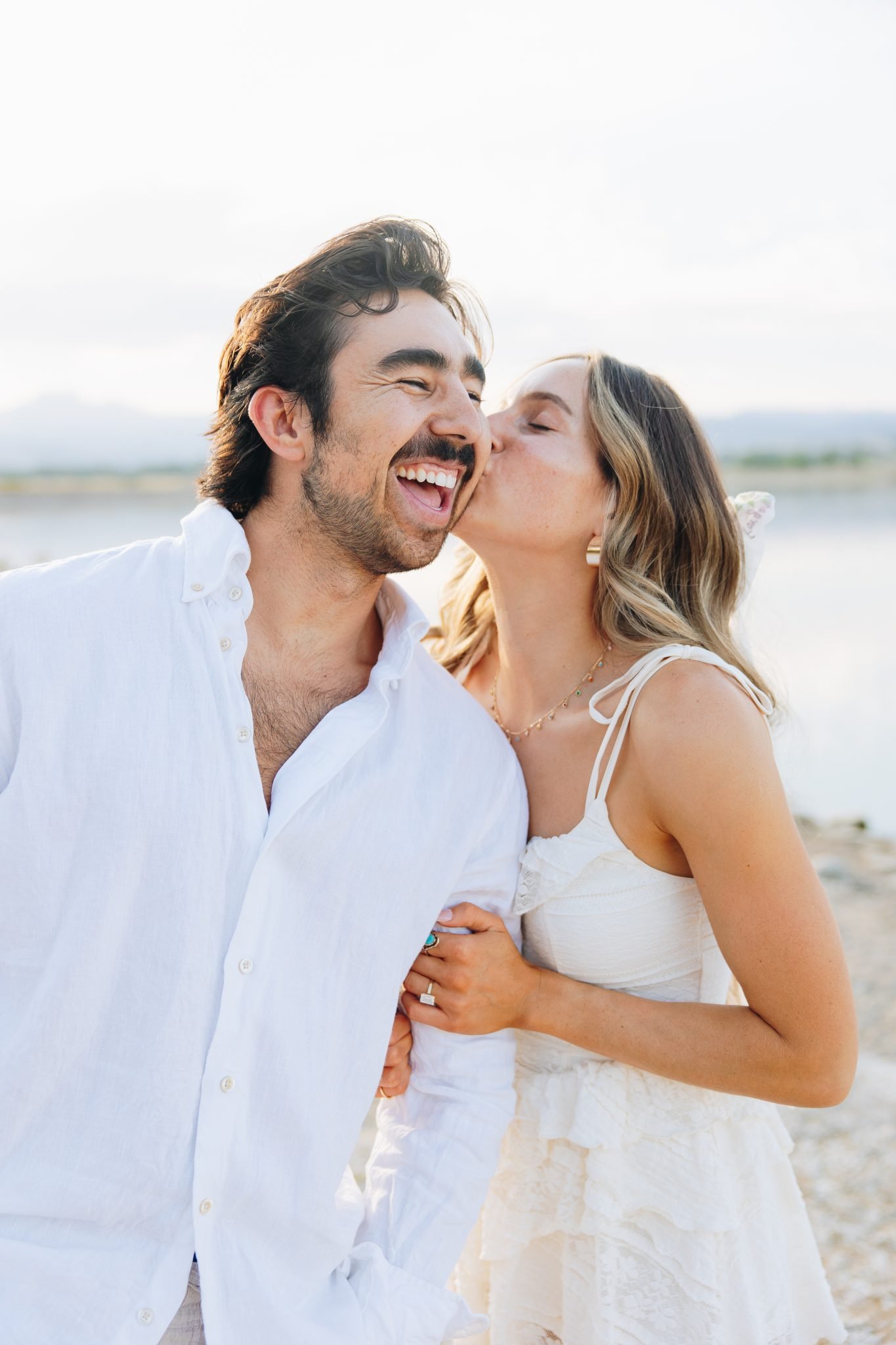 A close-up of the couple laughing together, showcasing their connection and the relaxed vibe of their fall Loveland engagements.