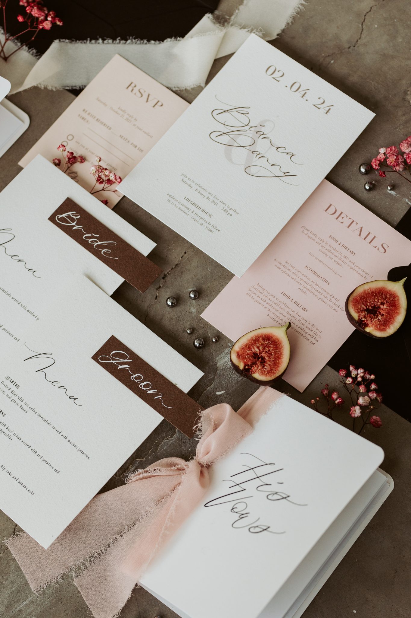 Elegant wedding stationery suite featuring blush and ivory tones with fig accents and silk ribbons, designed for a Valentine's Day Editorial.
