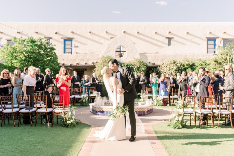 Bride and groom exchanging vows at Hacienda Del Sol, a stunning Arizona desert wedding venue with panoramic mountain views and lush gardens.