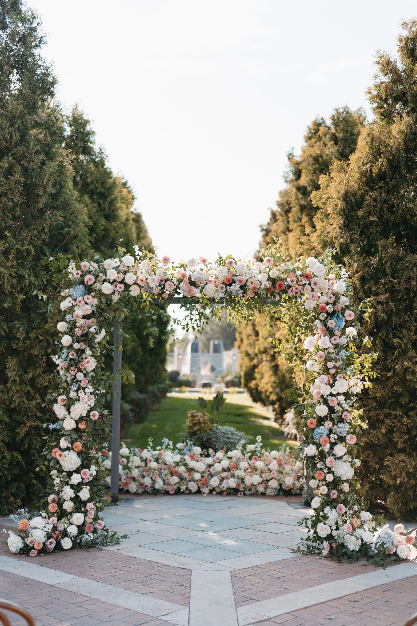 Beautiful floral arch with lush greenery and pastel blooms, ready for the ceremony at a Denver Botanic Gardens wedding.