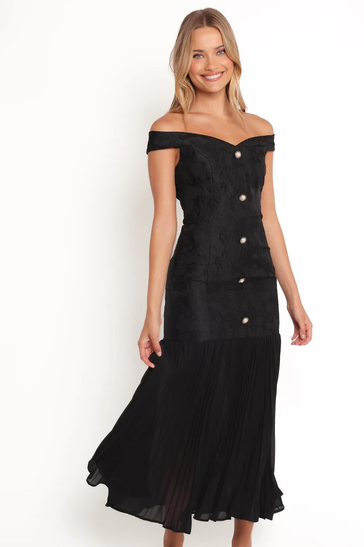 A sleek black maxi dress with a timeless cut, perfect for a black-tie wedding or cocktail event.