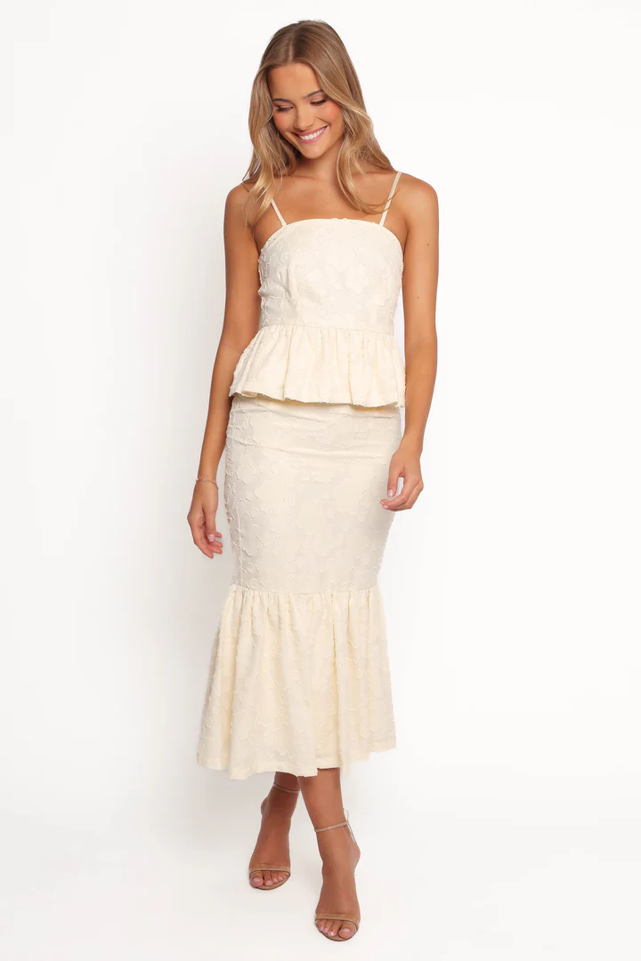 A pale yellow skirt set with a modern silhouette, ideal for engagement parties, wedding guests, or elopements.