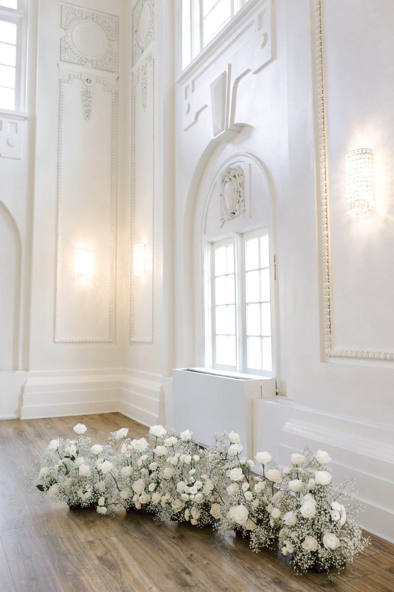 A romantic white rose and baby's breath floral arrangement for a wedding at commercial club salt lake city utah.