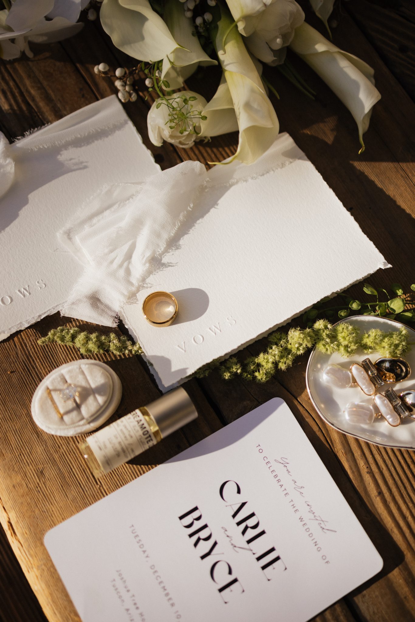 Flat lay of wedding vows, rings, and accessories, styled with soft, romantic details and natural elements, perfect for Tucson elopement inspiration rocky mountain bride.