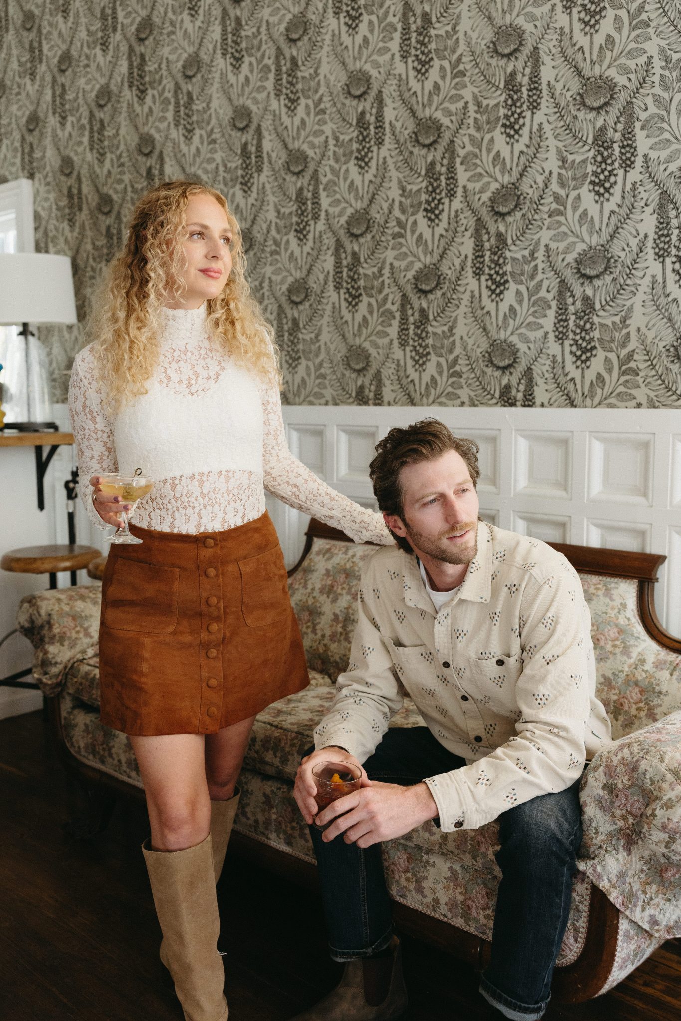 A stylish couple enjoys a cozy indoor moment during their Colorado fall engagement rocky mountain bride session, with vintage decor and warm, rustic tones.