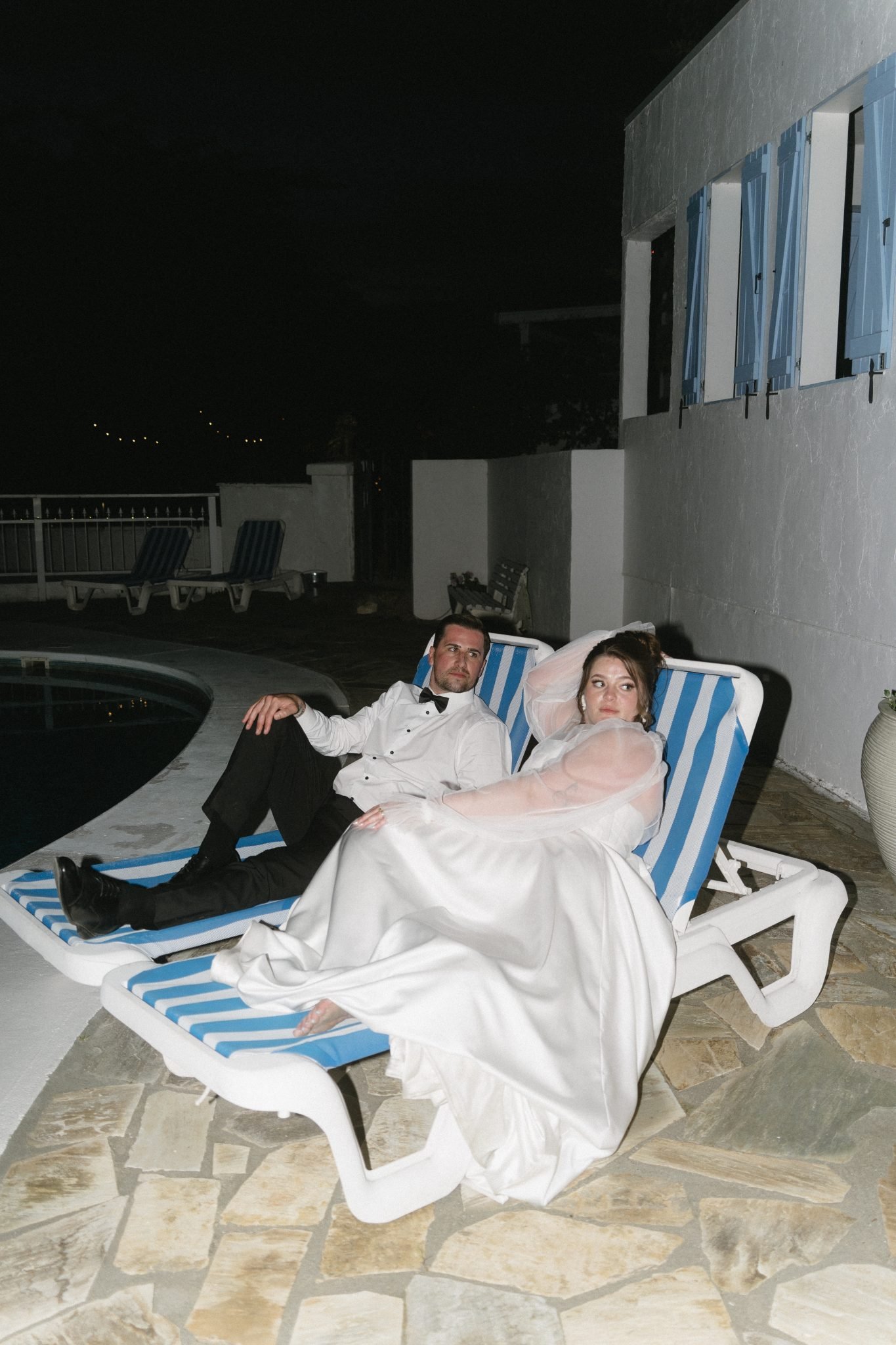 Newlyweds hanging out by the pool to end the night for their God’s Mountain Estate summer wedding