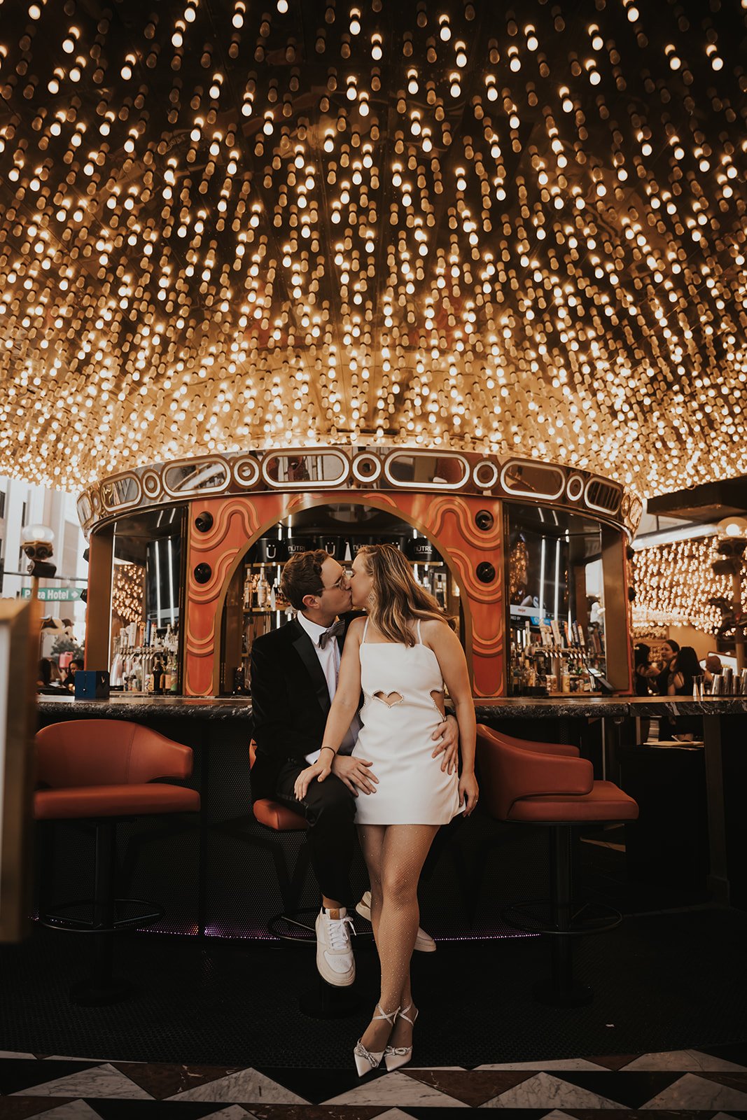 A romantic moment under glowing marquee lights during a Shore Lodge Idaho wedding rocky mountain bride celebration.