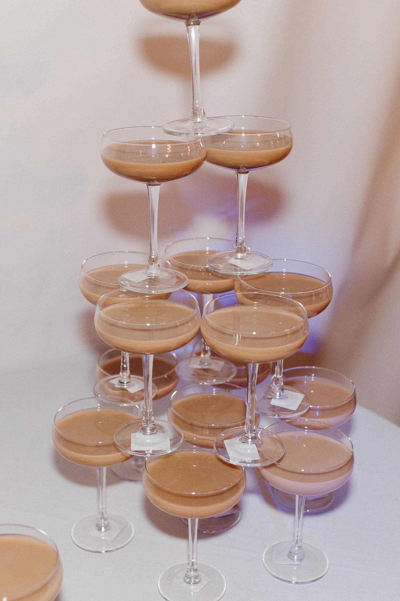 Tower of martinis arranged in coupe glasses for a unique reception drink display at St. Eugene Golf Resort & Casino British Columbia wedding.