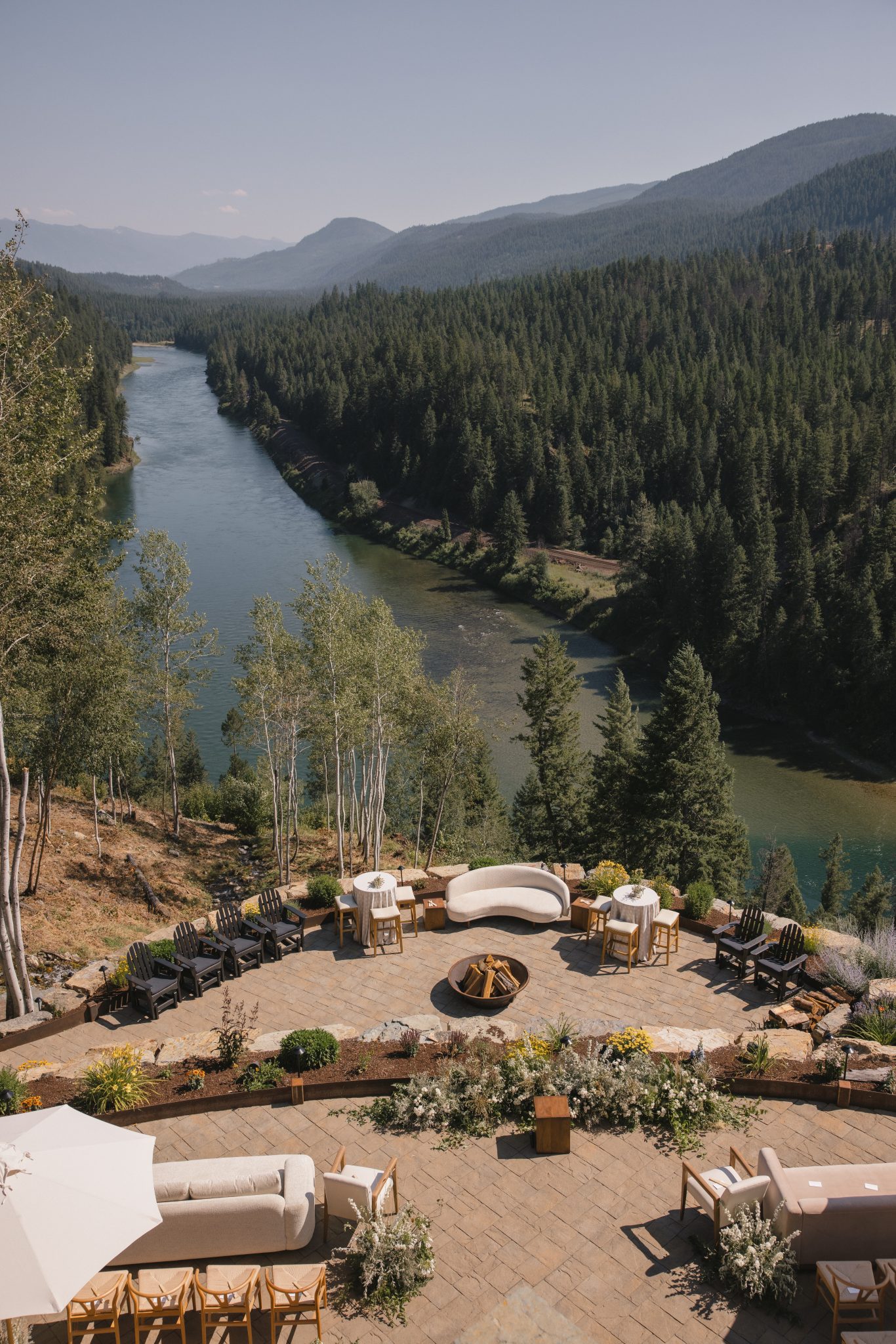 Expansive mountain and river view from the ceremony and cocktail area at a Summer private home wedding in Montana.