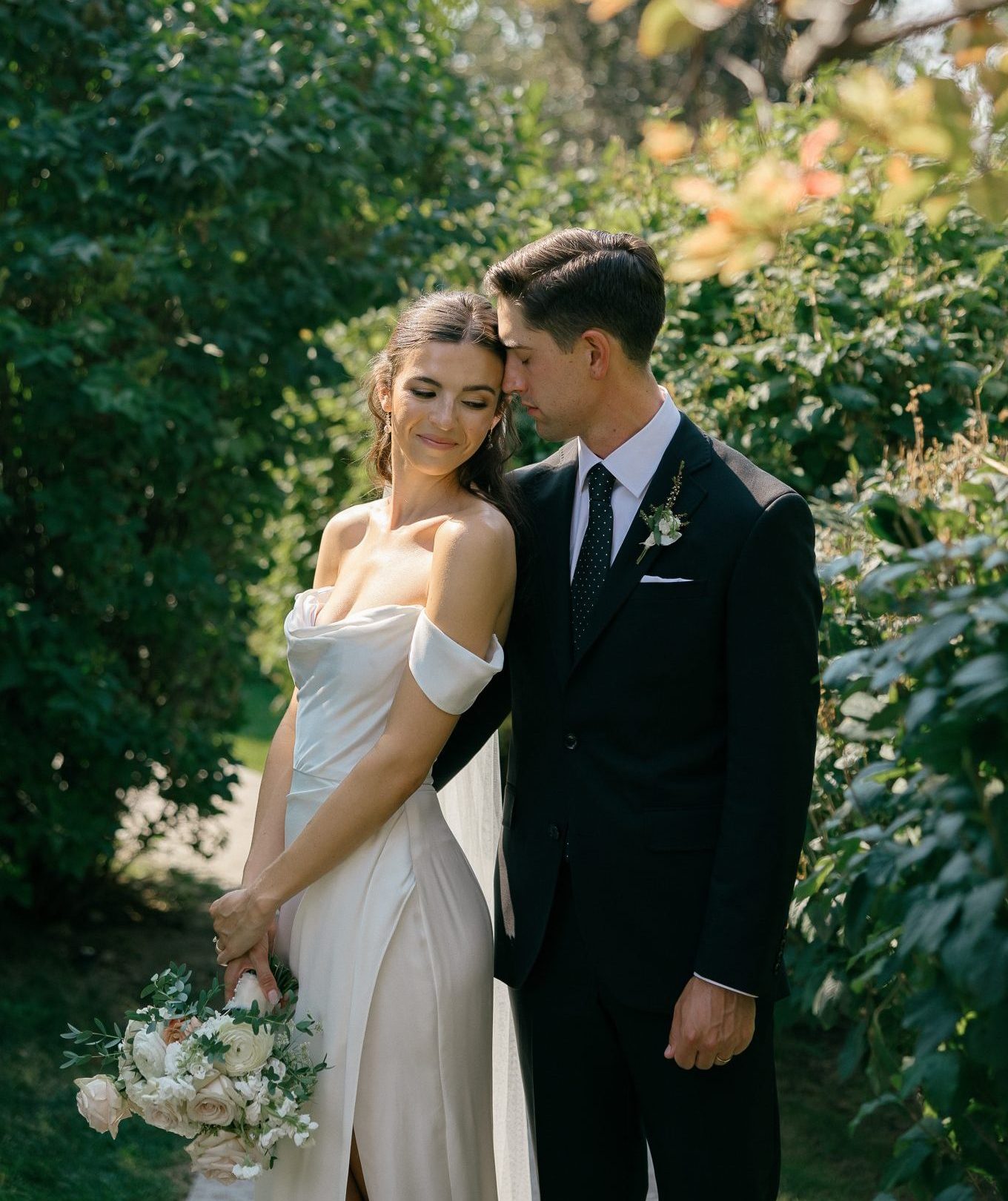 Romantic portrait of bride and groom surrounded by lush greenery at an idaho wedding rocky mountain bride celebration.