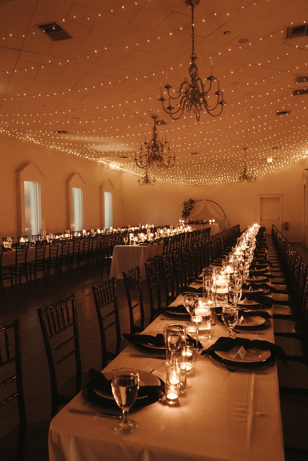 Create a the overall description of the wedding photos uploaded and include previous text information you provided to create a custom, detailed introduction to the wedding blog. Here are some ideas to use in the two-three sentences: the colors of the florals, style of the wedding dress, groom’s attire, bridesmaid, and groomsmen attire, the ceremony set up, ceremony decor and florals, cocktail decor, dinner decor and style of the table settings, cake and dessert items and display, dance floor props, or the grand exit. I don’t want the information to sound forced.