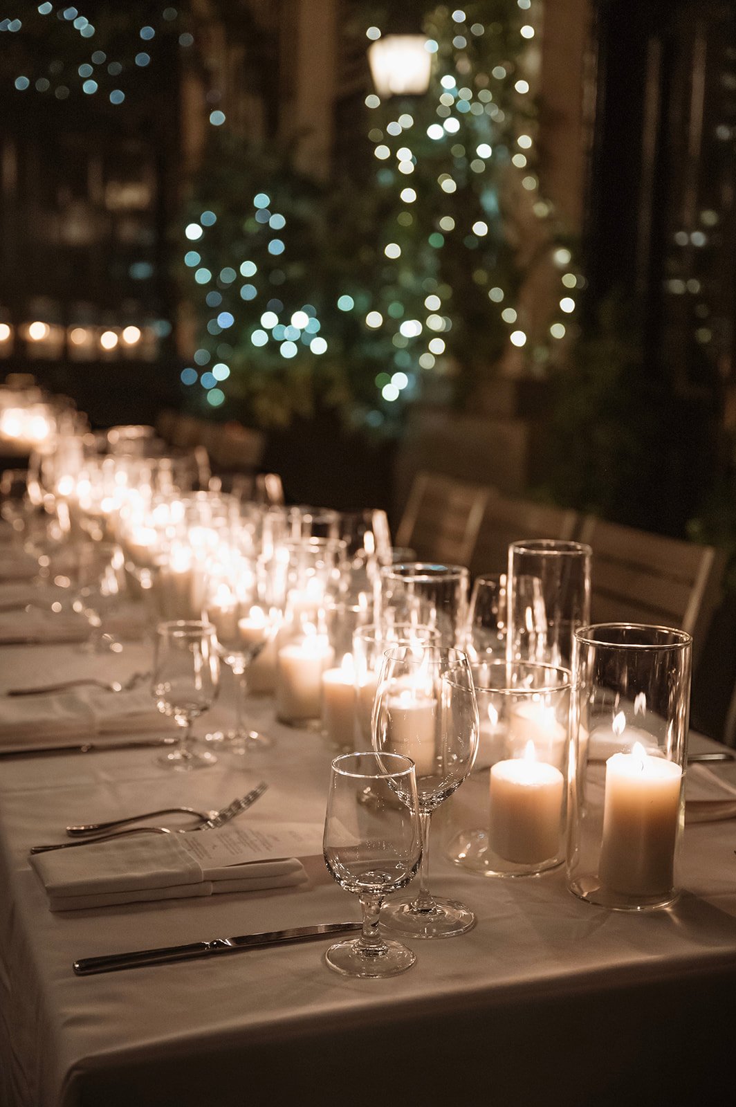 Elegant candlelit reception table with glassware and warm lighting at a Brix and Mortar wedding rocky mountain bride celebration.