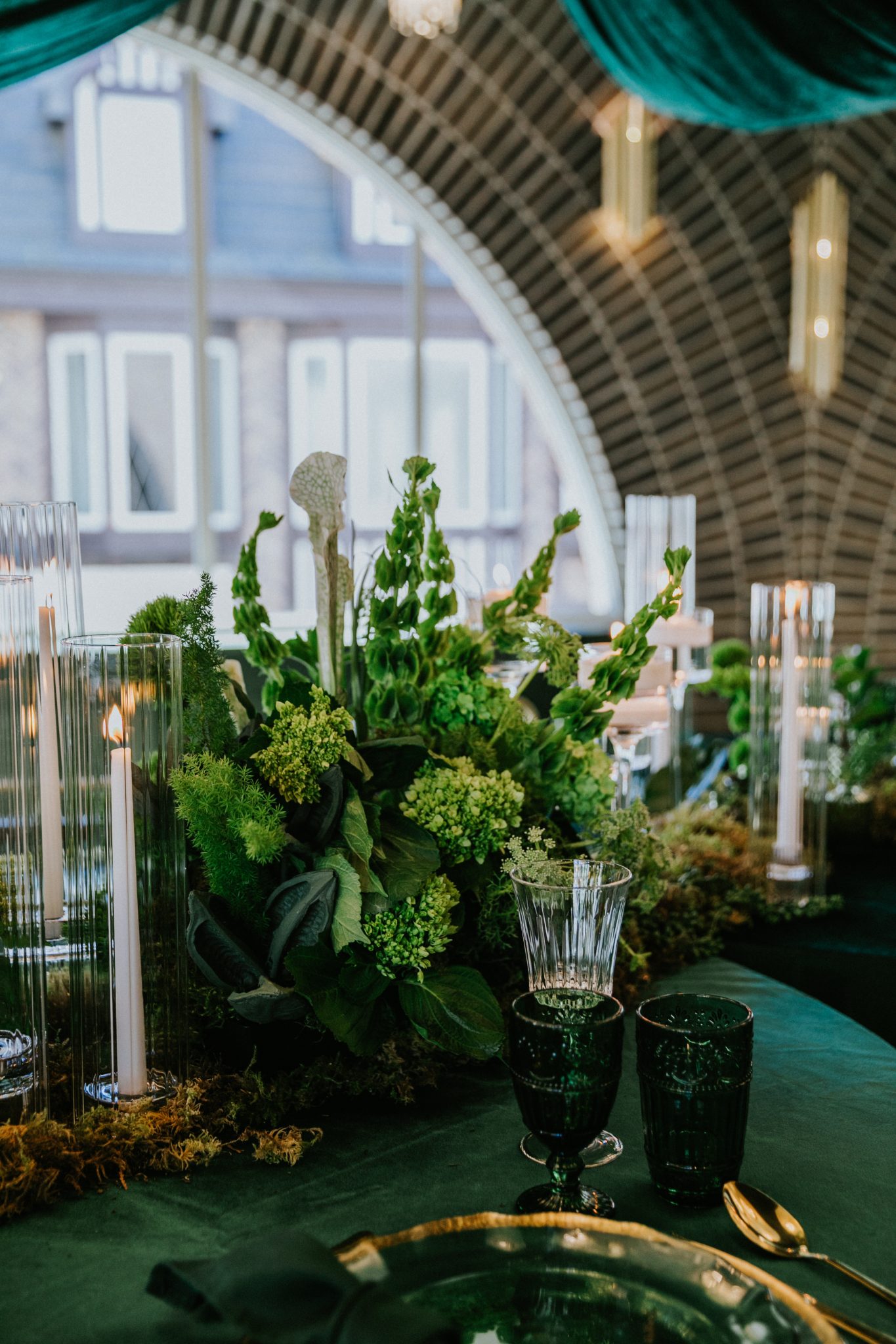 Layered greens and candlelight centerpiece design at the Grand Hall for Grand Hall wicked wedding inspiration rocky mountain bride.
