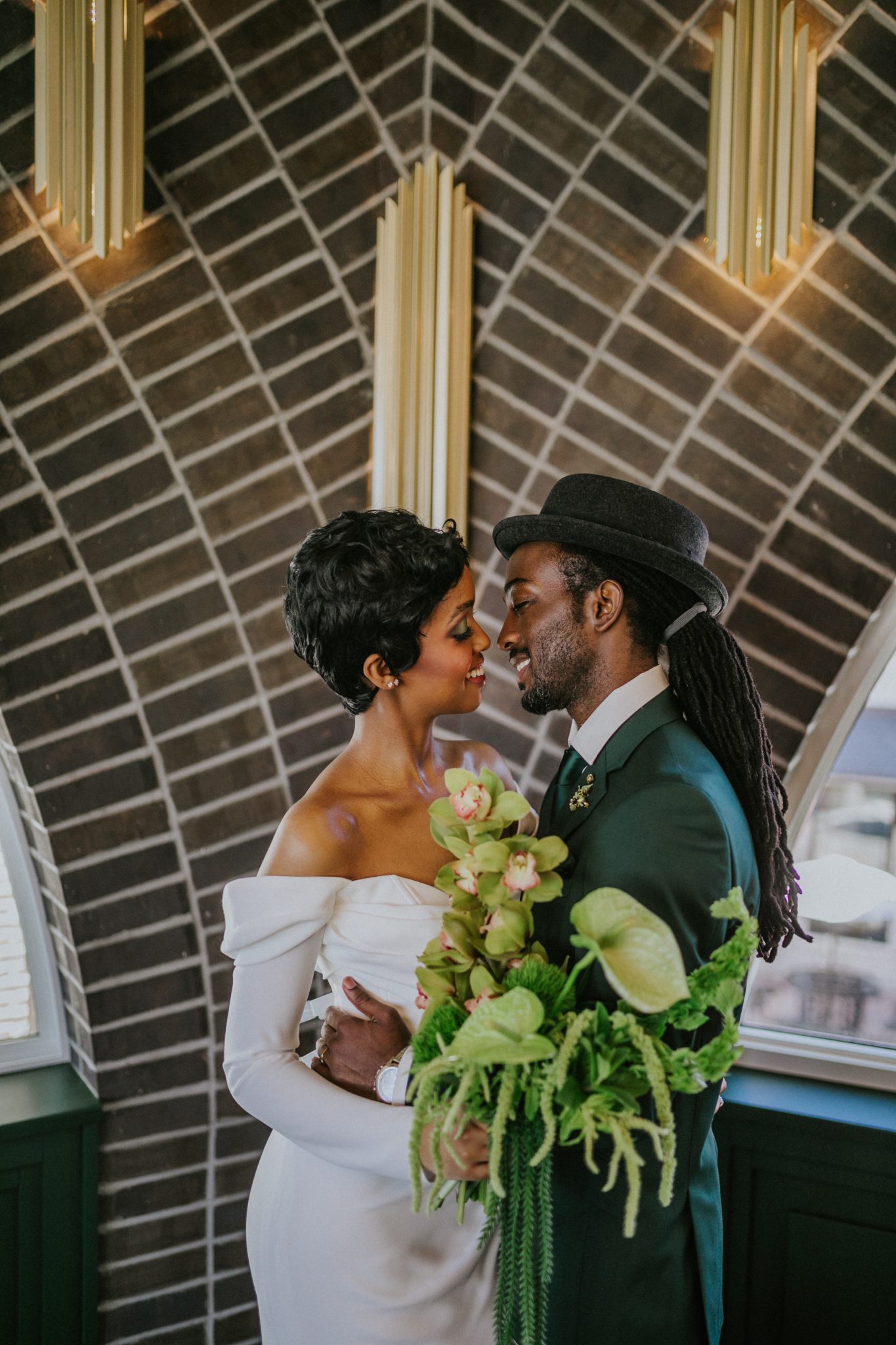 Couple sharing a moment surrounded by dramatic architecture and bold florals at the Grand Hall wicked wedding inspiration rocky mountain bride.