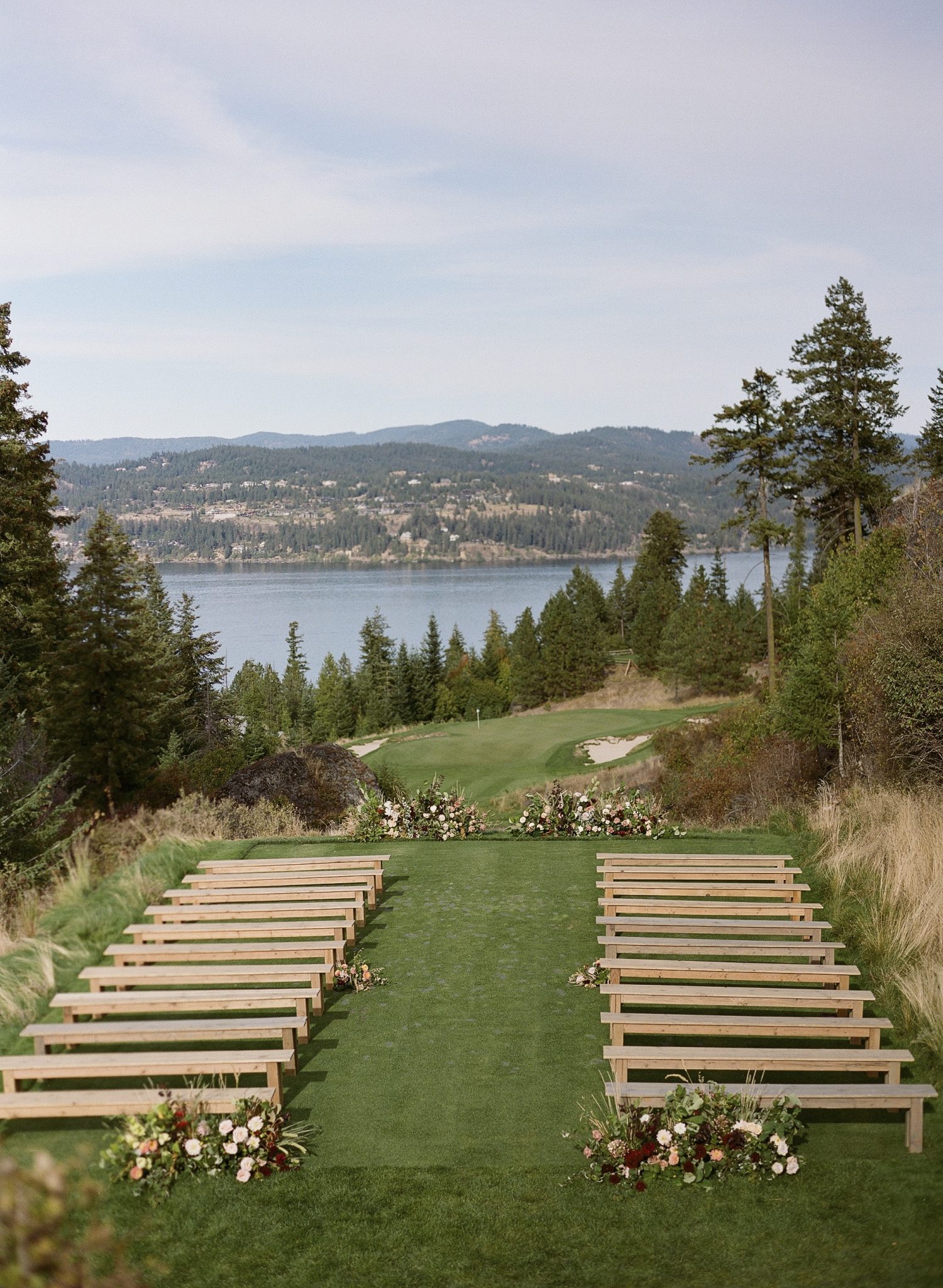 Stunning outdoor ceremony setup with lake and mountain views at a couer d'alene wedding gozzer ranch rocky mountain bride destination.