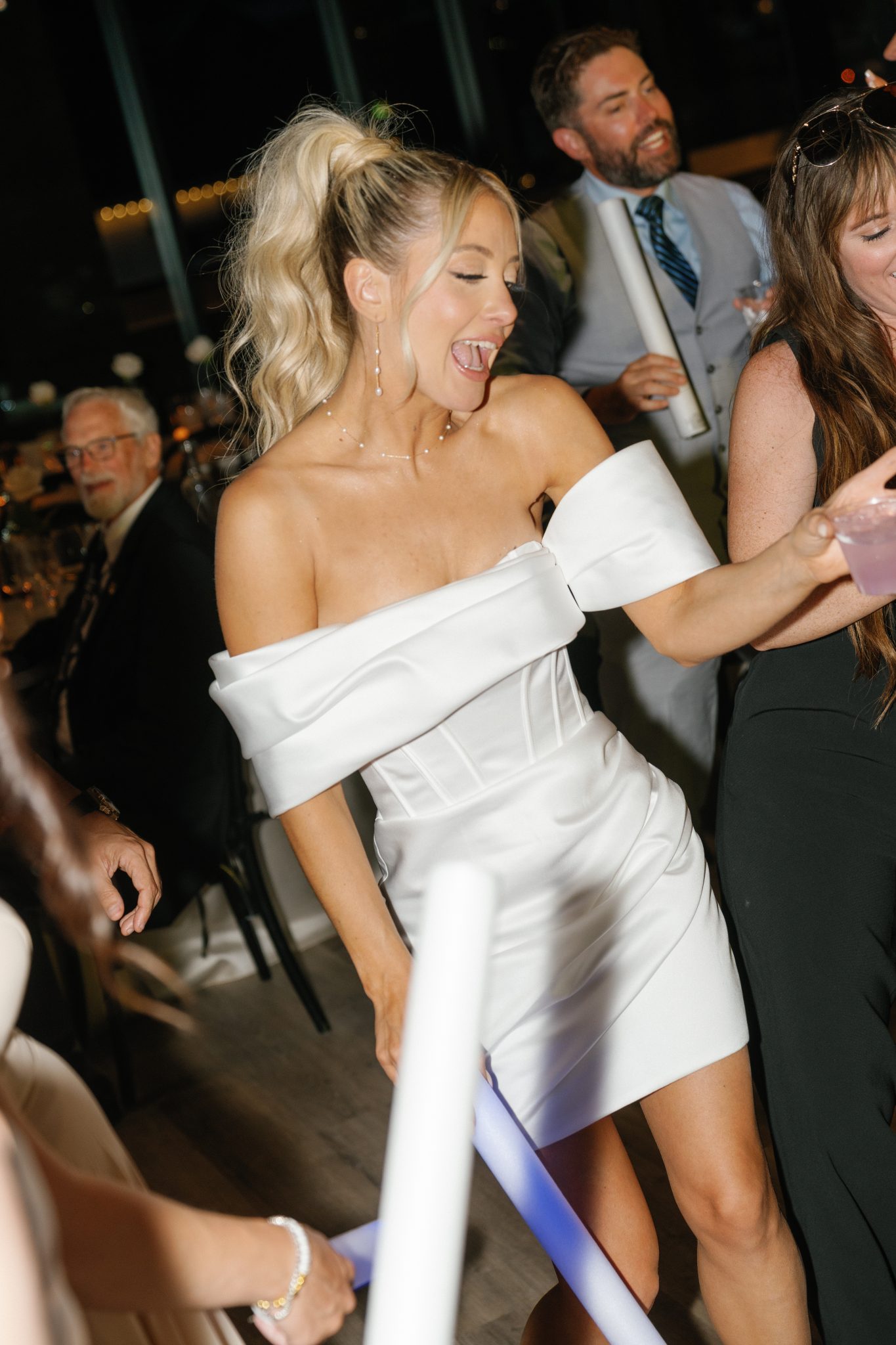 Bride changes into a white satin mini dress for the reception at a park city utah wedding rocky mountain bride event.