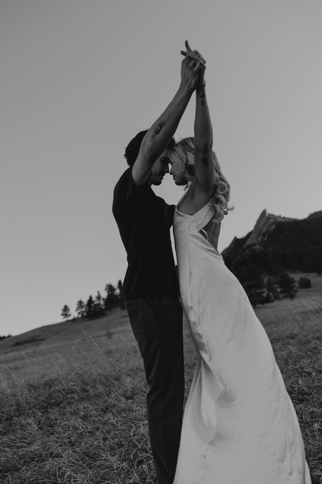 Dreamy silhouette of couple dancing at sunset during Jo Kulesza Weddings Boulder engagement session rocky mountain bride surrounded by Colorado’s iconic peaks.