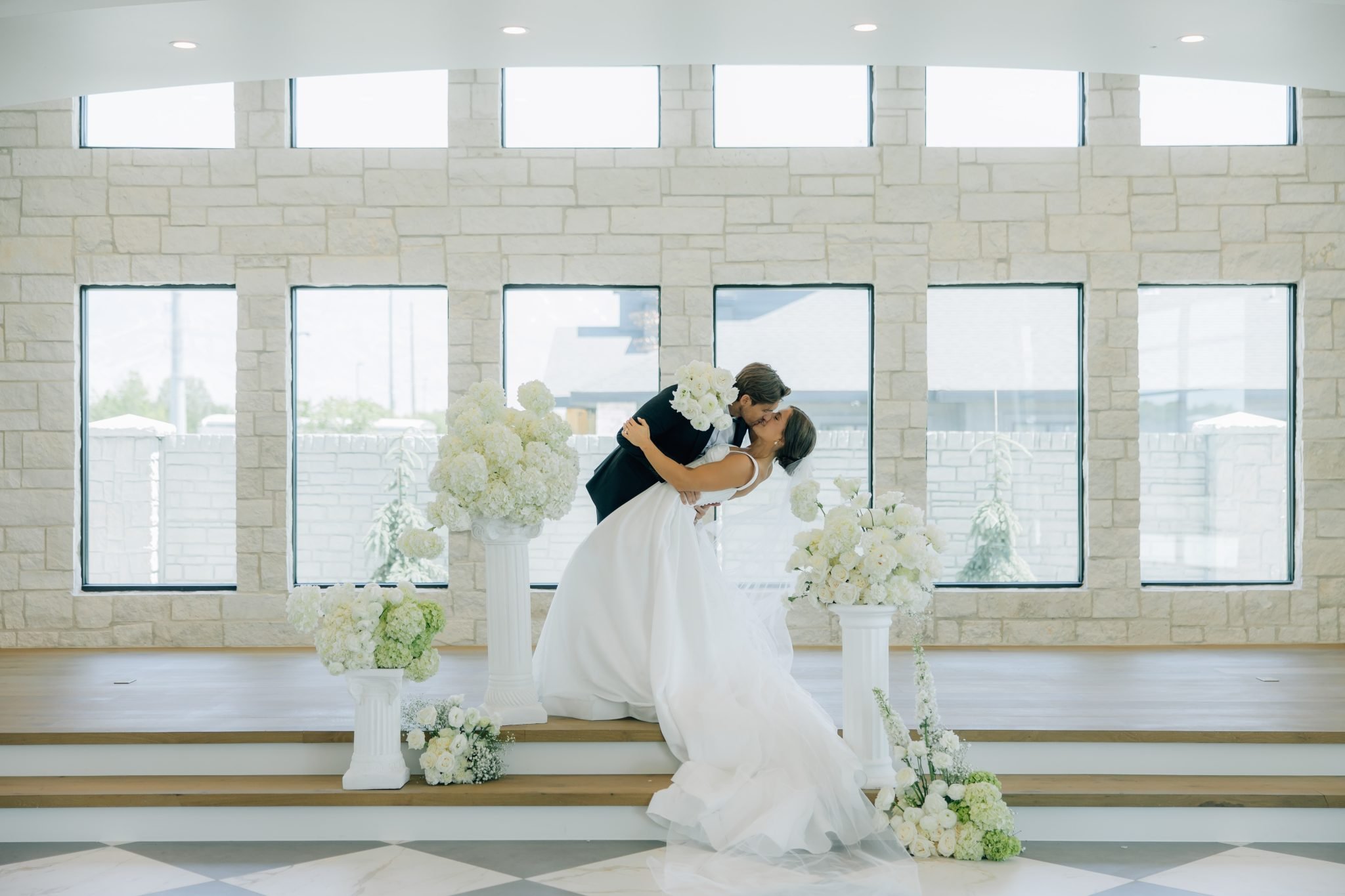 groom dipping bride and kissing her