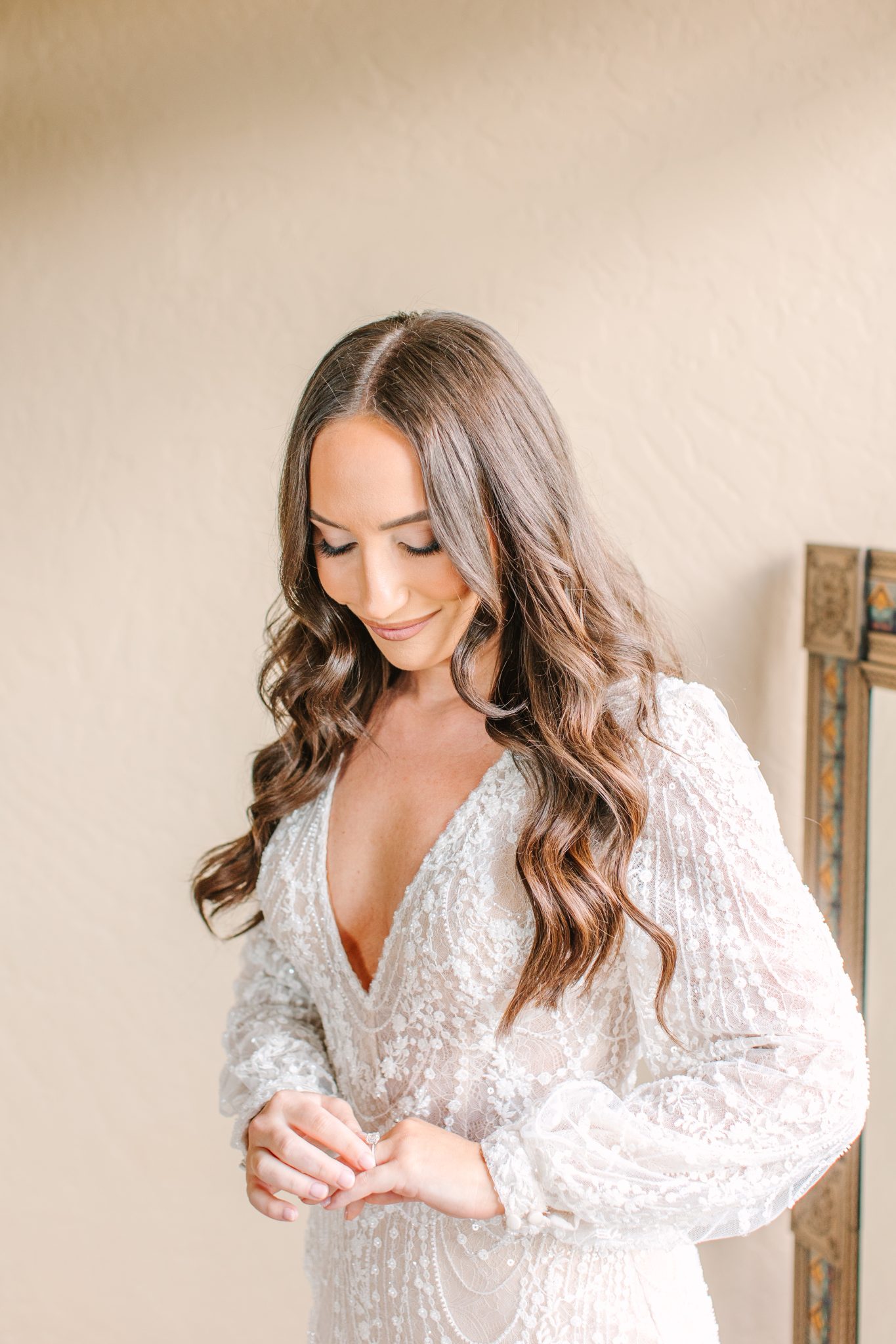 Bride preparing for her Purgatory Resort winter wedding rocky mountain bride celebration, wearing an elegant lace gown with soft waves and natural makeup.