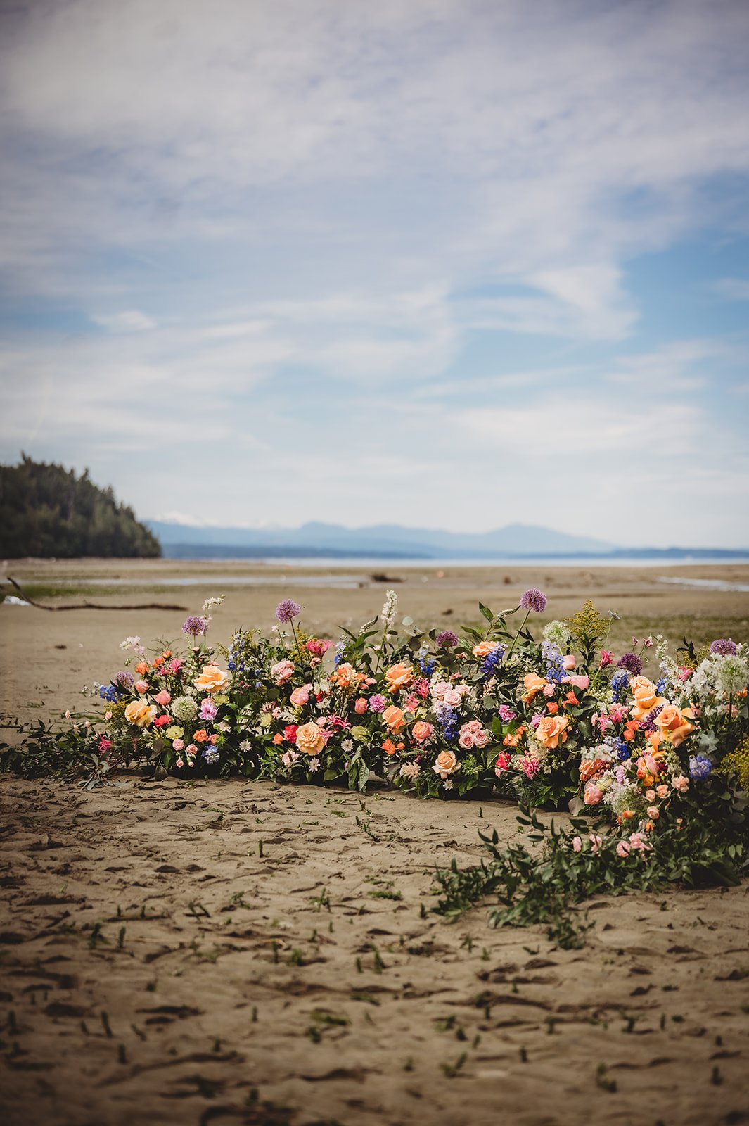 Stunning beachside floral arrangement with mountain views for a private estate wedding in British Columbia Rocky Mountain Bride.