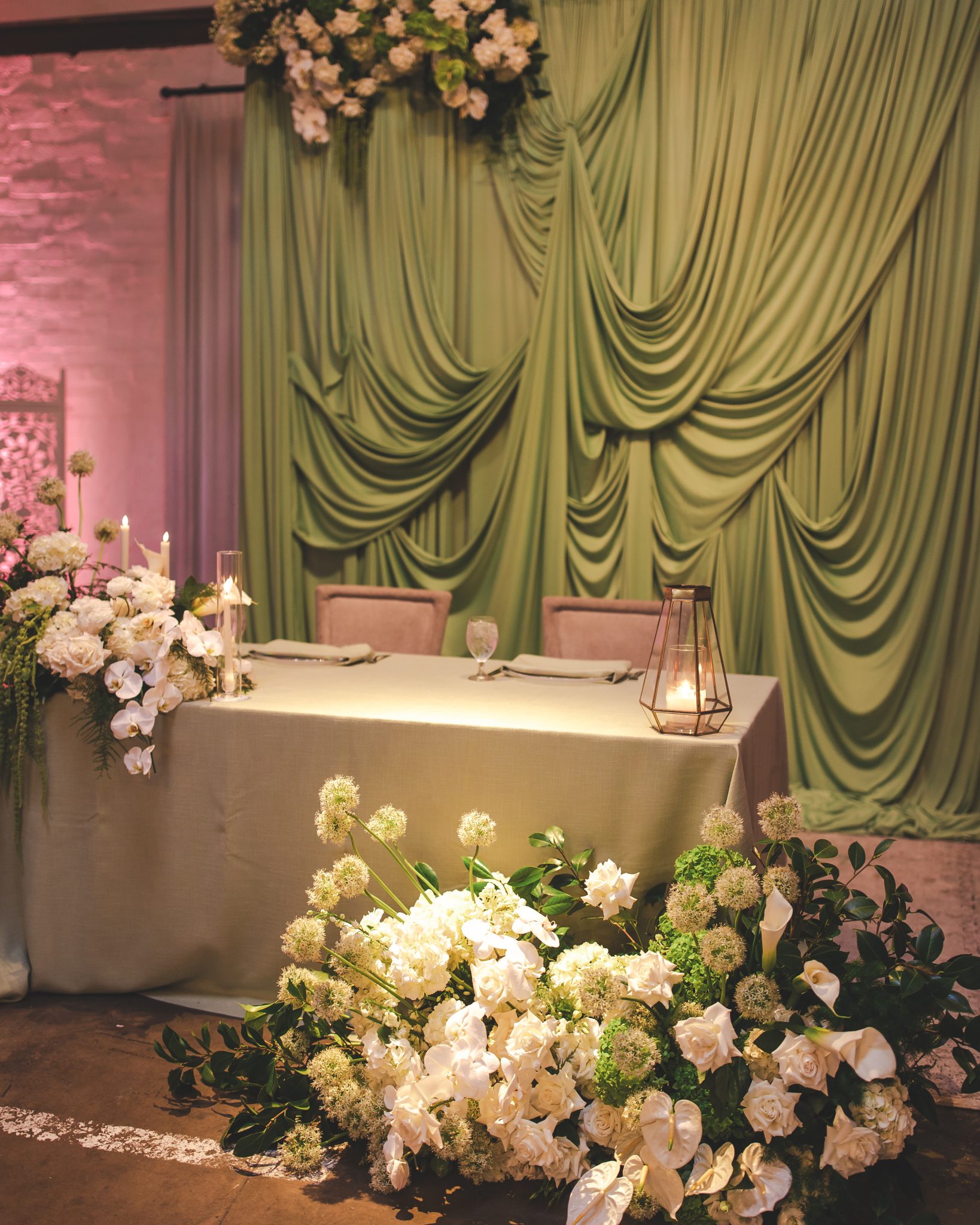 Elegant sweetheart table with lush greenery and white florals at The Doyle spring wedding las vegas rocky mountain bride
